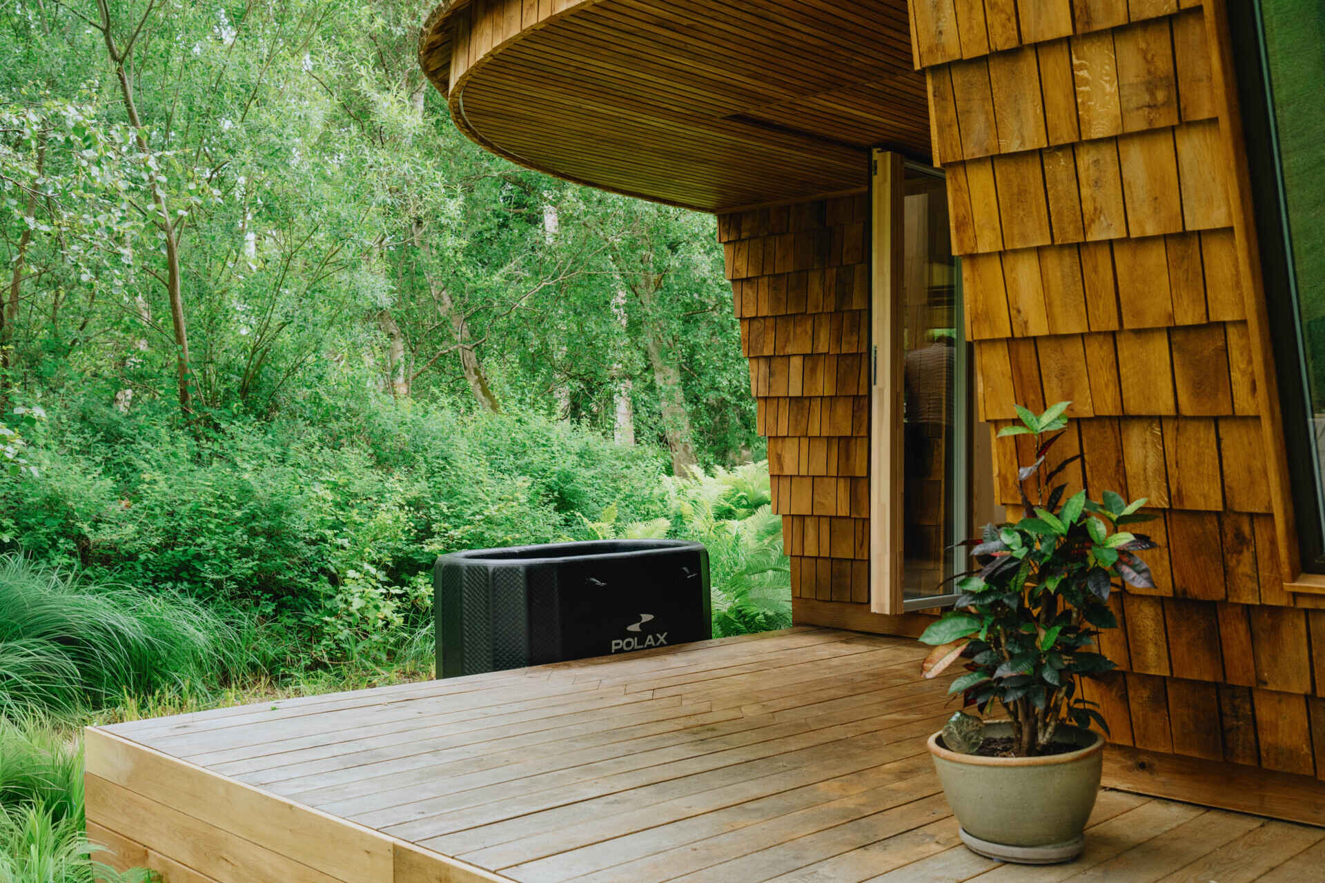 Natural timber, digital fabrication, and a low-carbon approach shape a garden house's warm exterior and efficient construction.