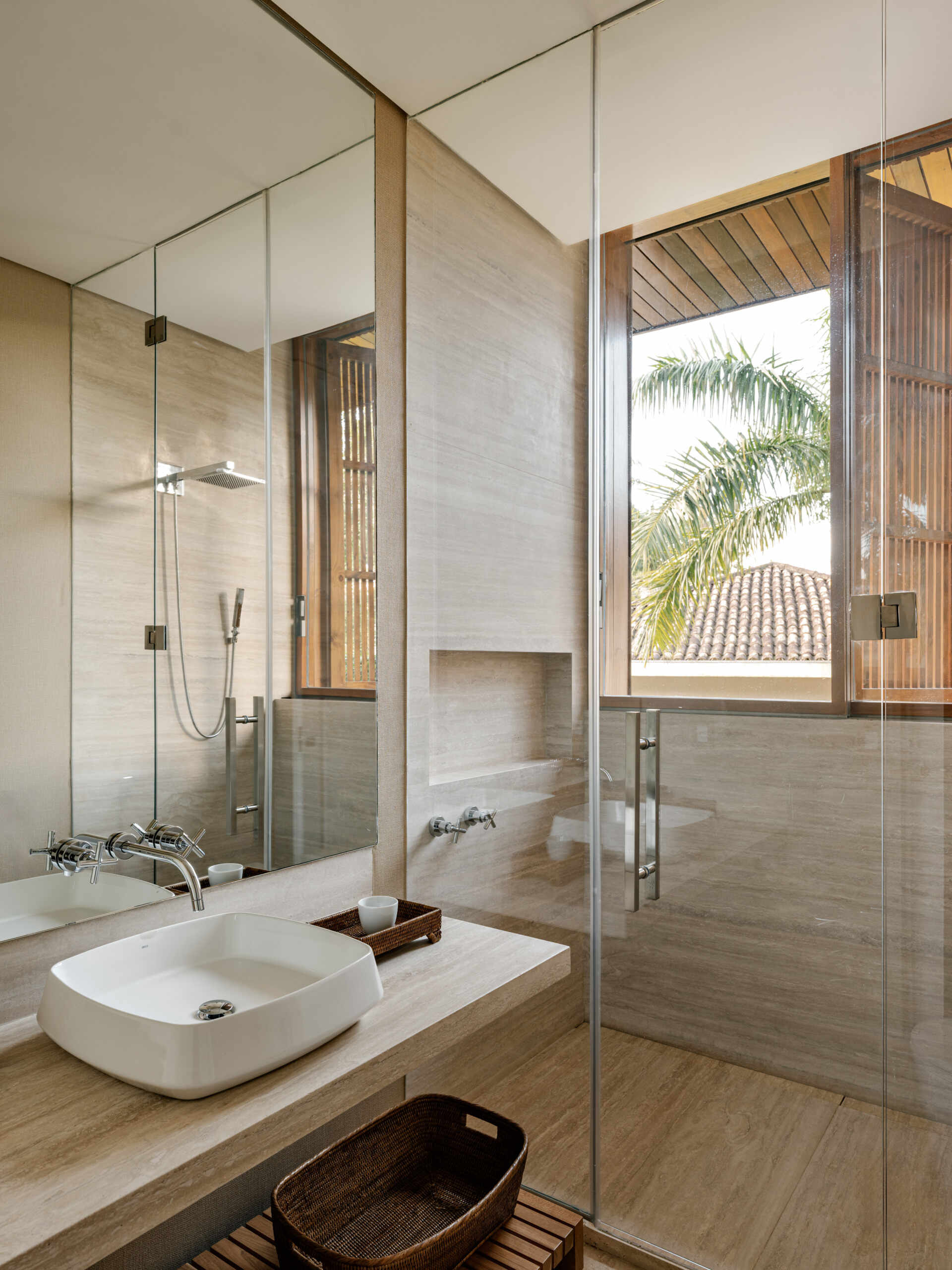 Natural stone and warm timber details give these contemporary guest bathrooms a timeless feel.
