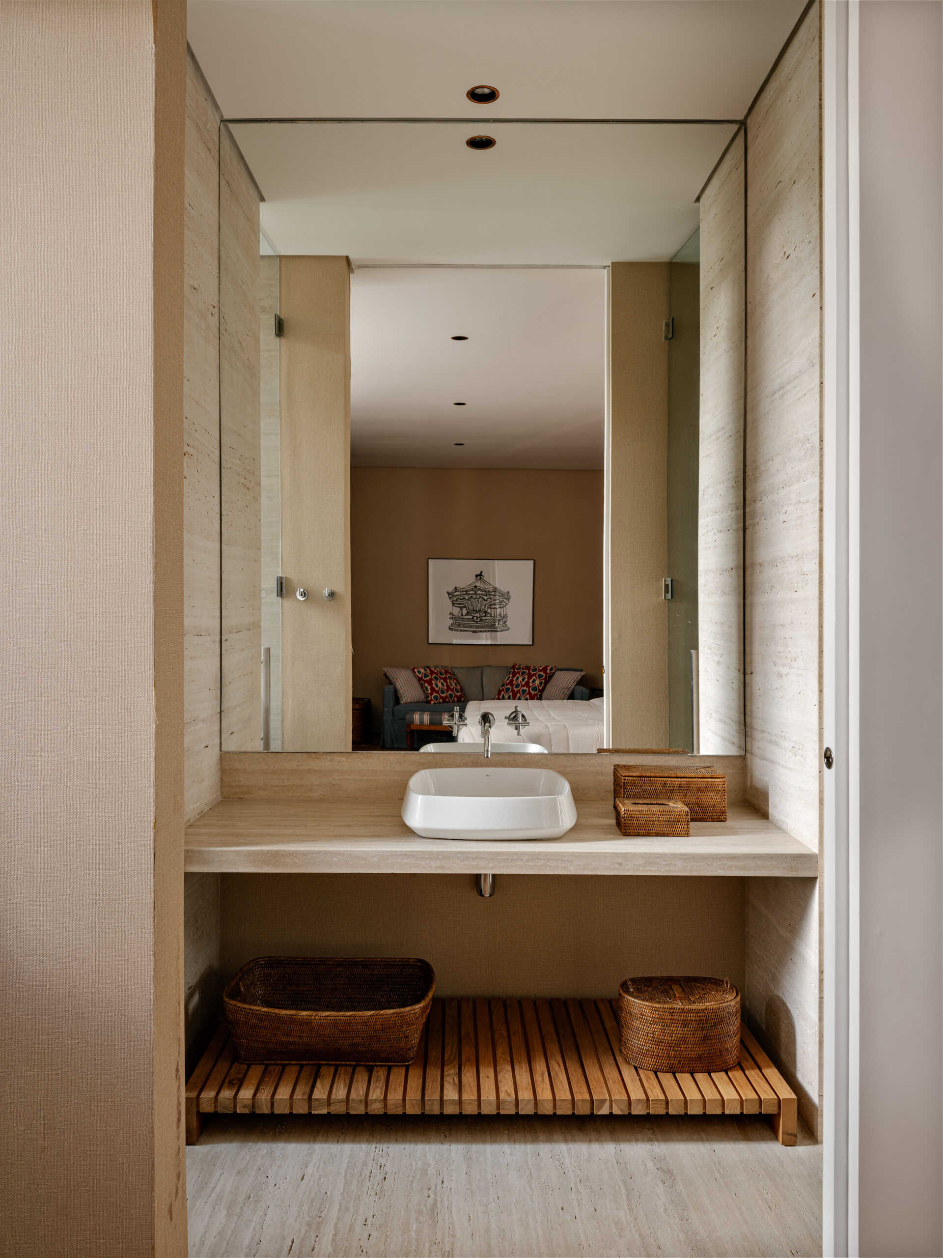 Natural stone and warm timber details give these contemporary guest bathrooms a timeless feel.