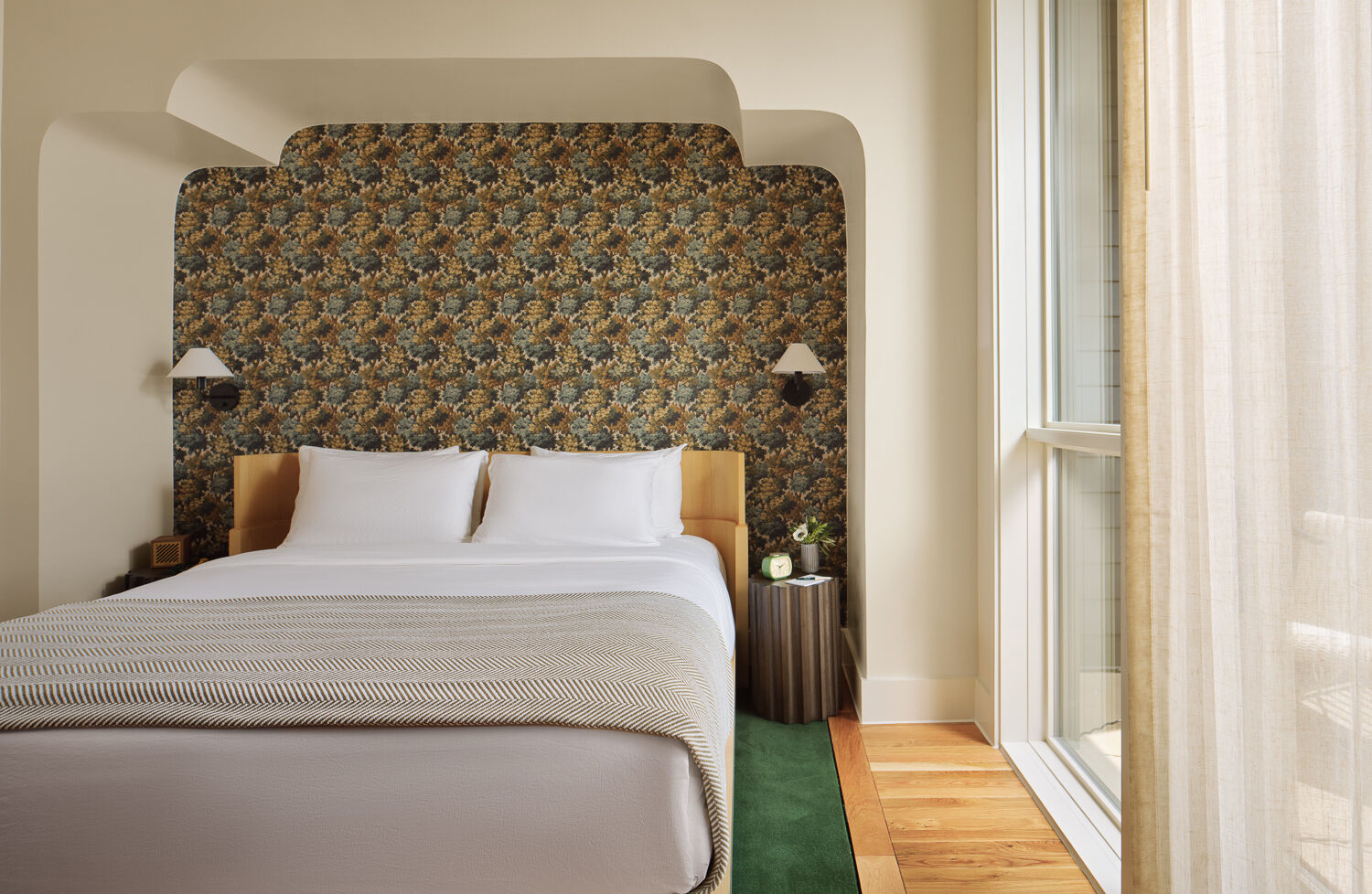Forest greens, floral wallpaper, white oak millwork and elegant finishes give this boutique hotel a welcoming character.