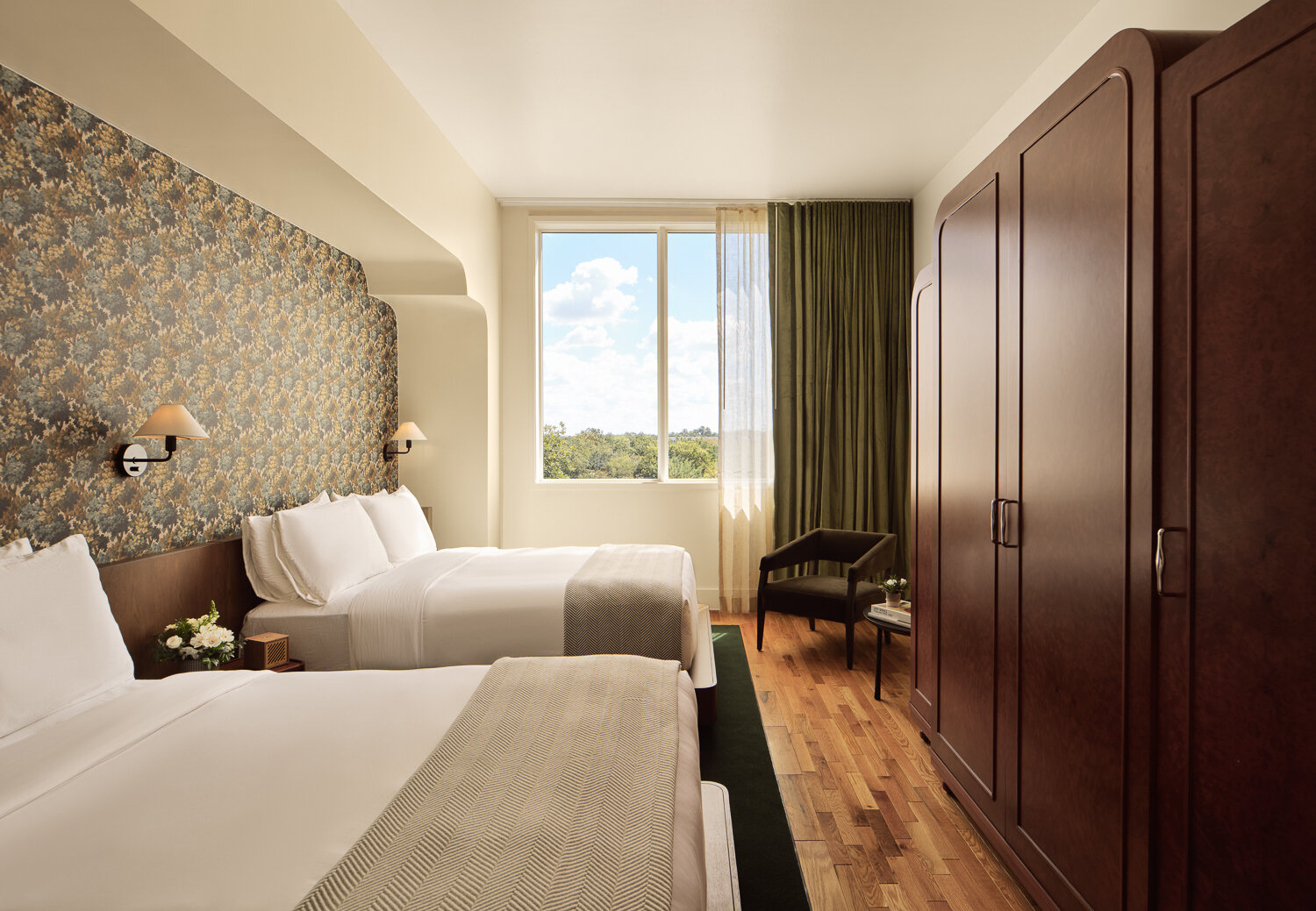 Forest greens, floral wallpaper, white oak millwork and elegant finishes give this boutique hotel a welcoming character.