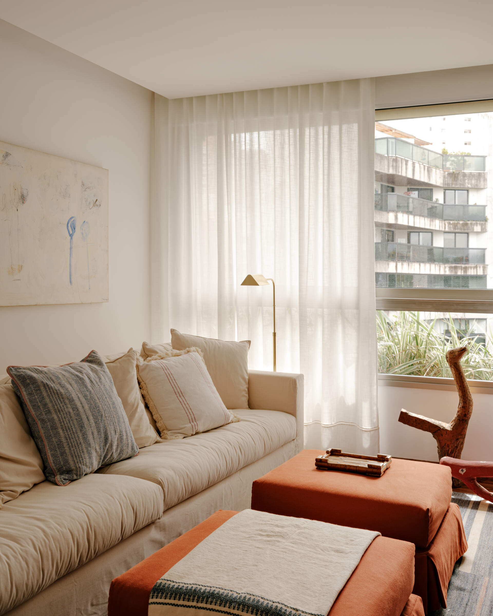A cosy media room shows how custom shelving, artwork and warm colours can make a TV space feel more inviting.