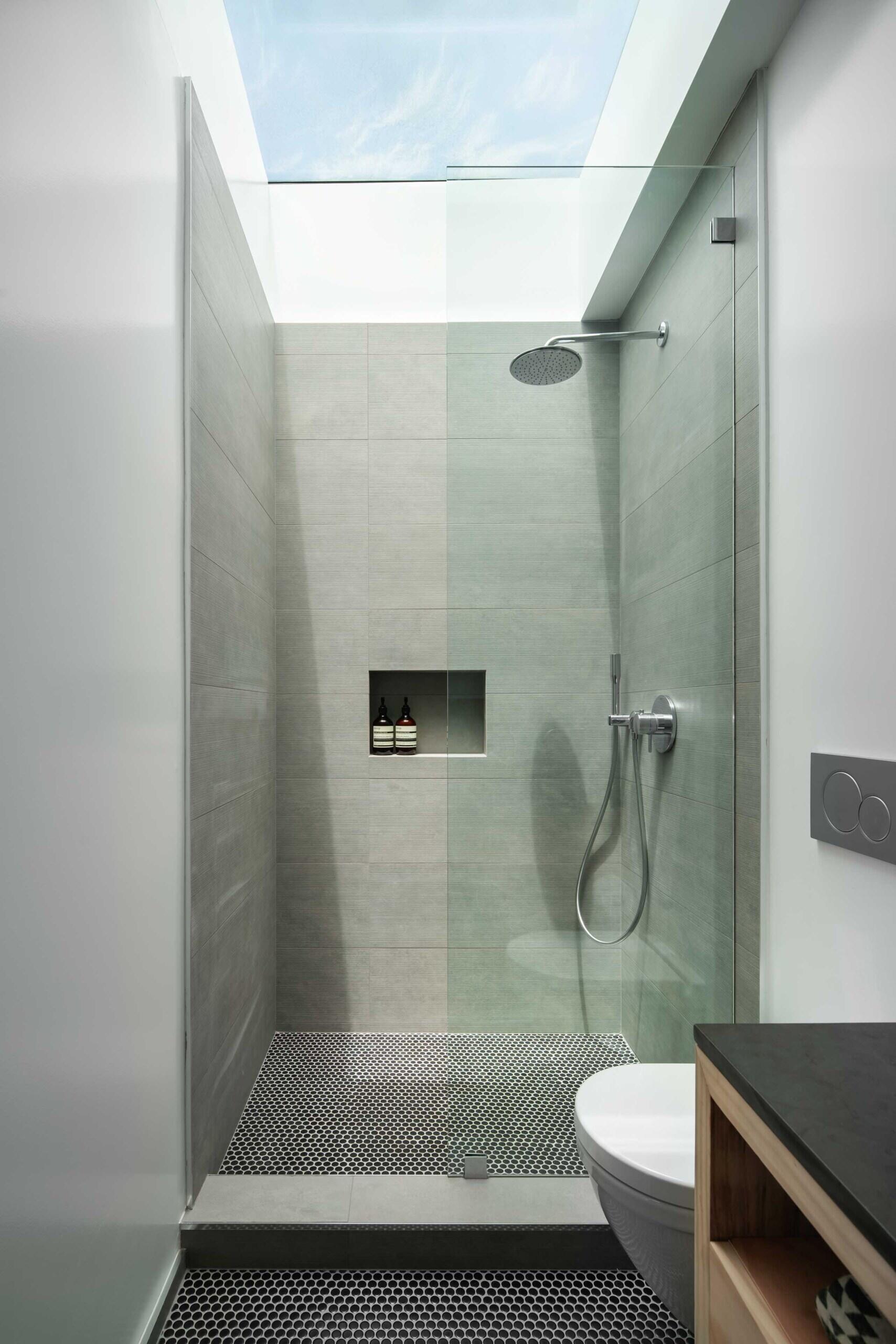 A modern shower with a skylight above.