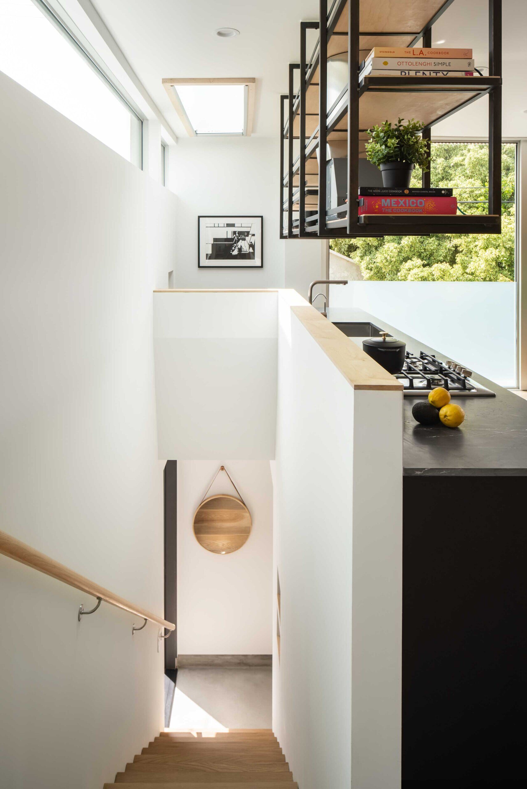 Tour this clever studio apartment where one open room includes a full kitchen, living space, bedroom, and bathroom without feeling cramped.