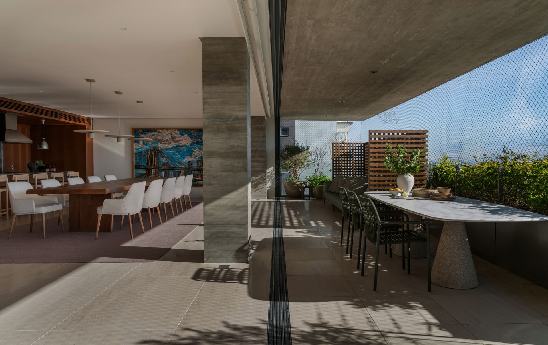 Matching limestone floors blur the line between the living room and terrace, creating one expansive entertaining space.