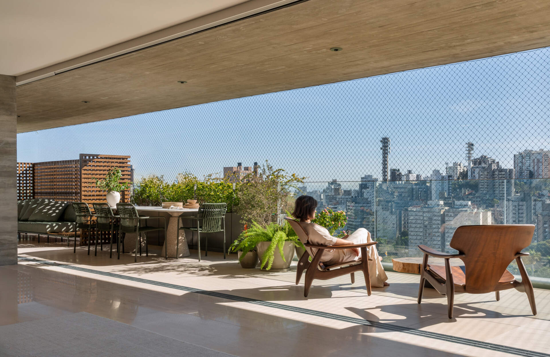 Matching limestone floors blur the line between the living room and terrace, creating one expansive entertaining space.