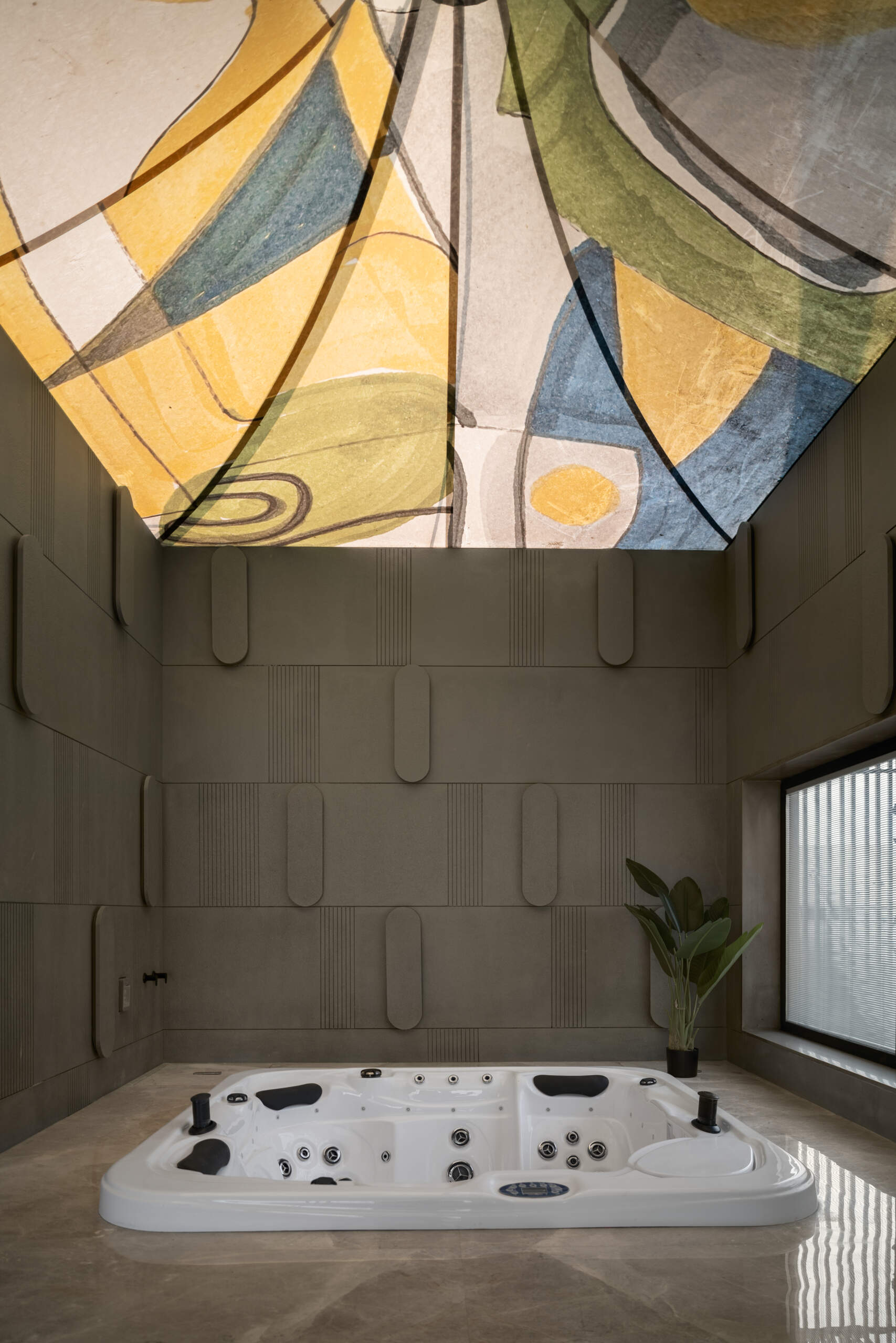 A jacuzzi beneath a sculptural fabric installation creates one of the home's most immersive wellness spaces.