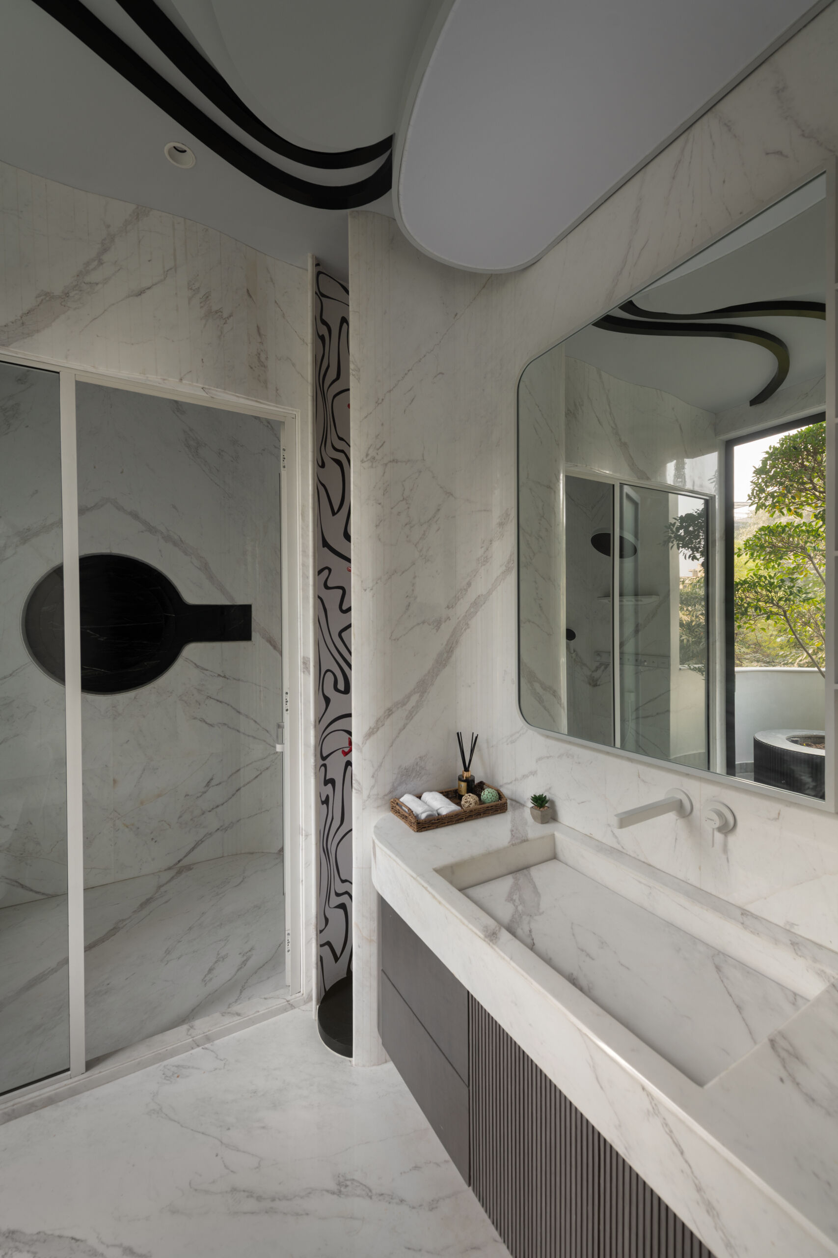 Stone, plaster and beautifully controlled lighting bring warmth and texture to these contemporary bathrooms.