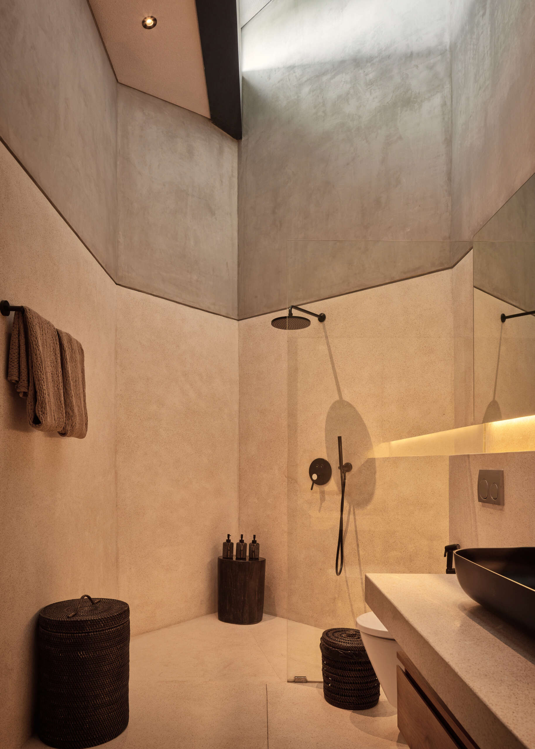Lighter finishes bring a fresh contrast to the bathrooms, balancing the darker palette used throughout Villa Suki.