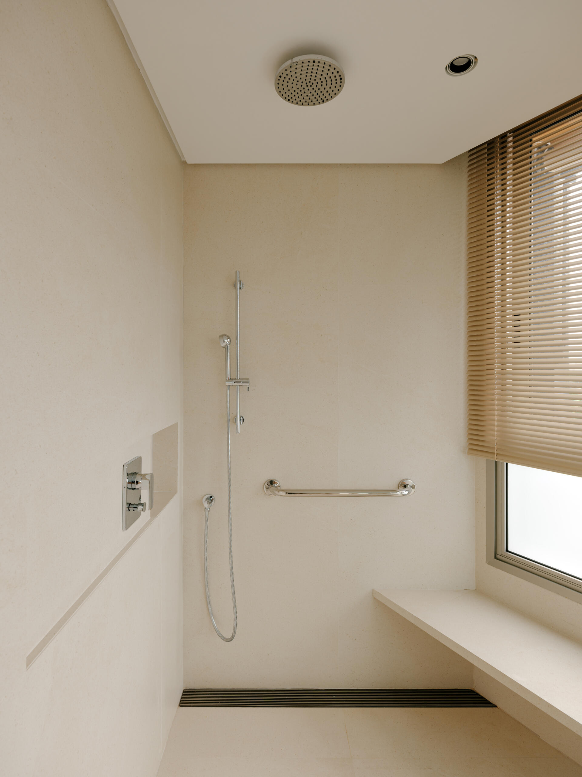Circular joinery details, warm timber and softly illuminated mirrors create elegant contemporary bathrooms.