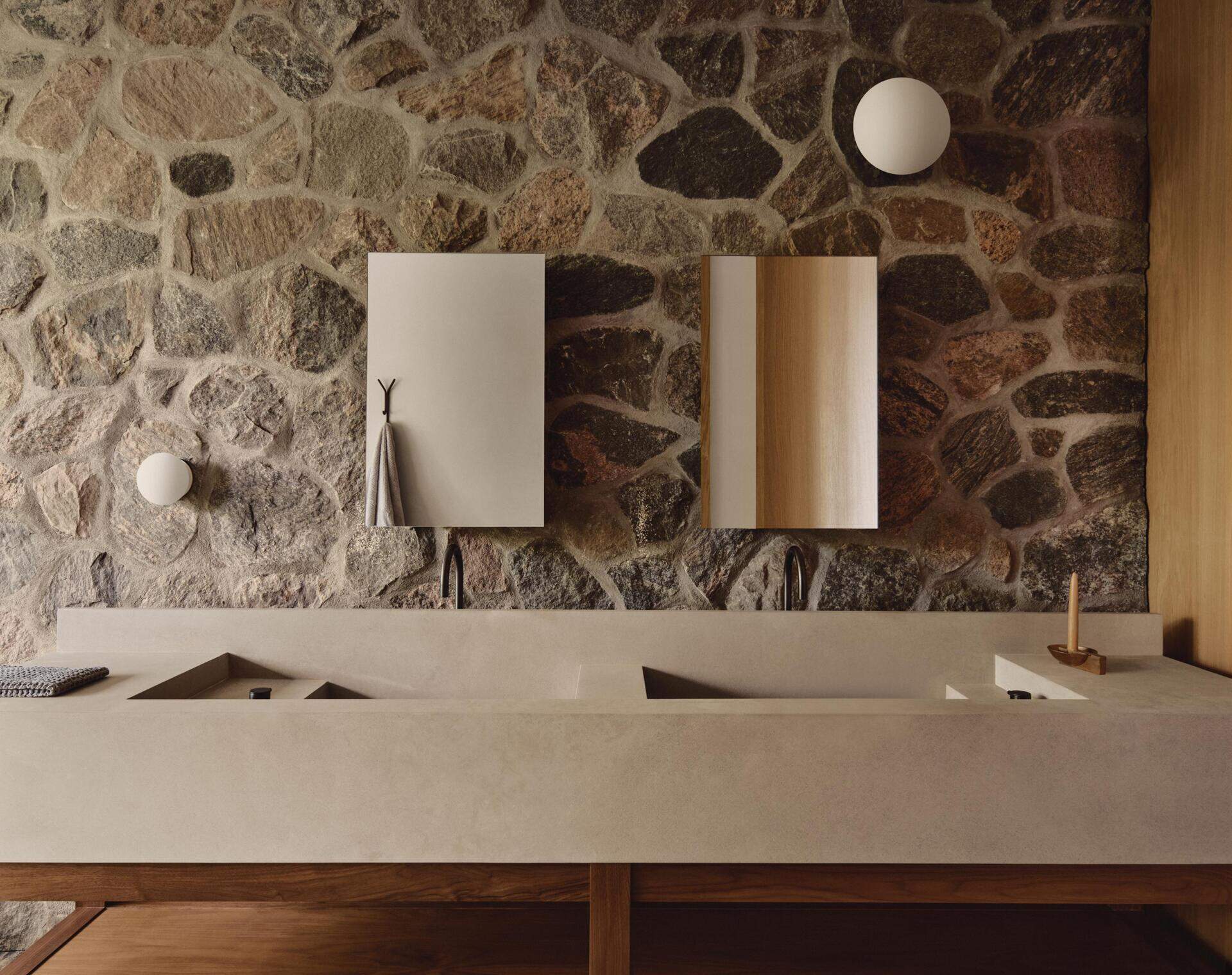 Stone sinks, a ceramic tub and textured shower flooring make this ensuite beautifully timeless.