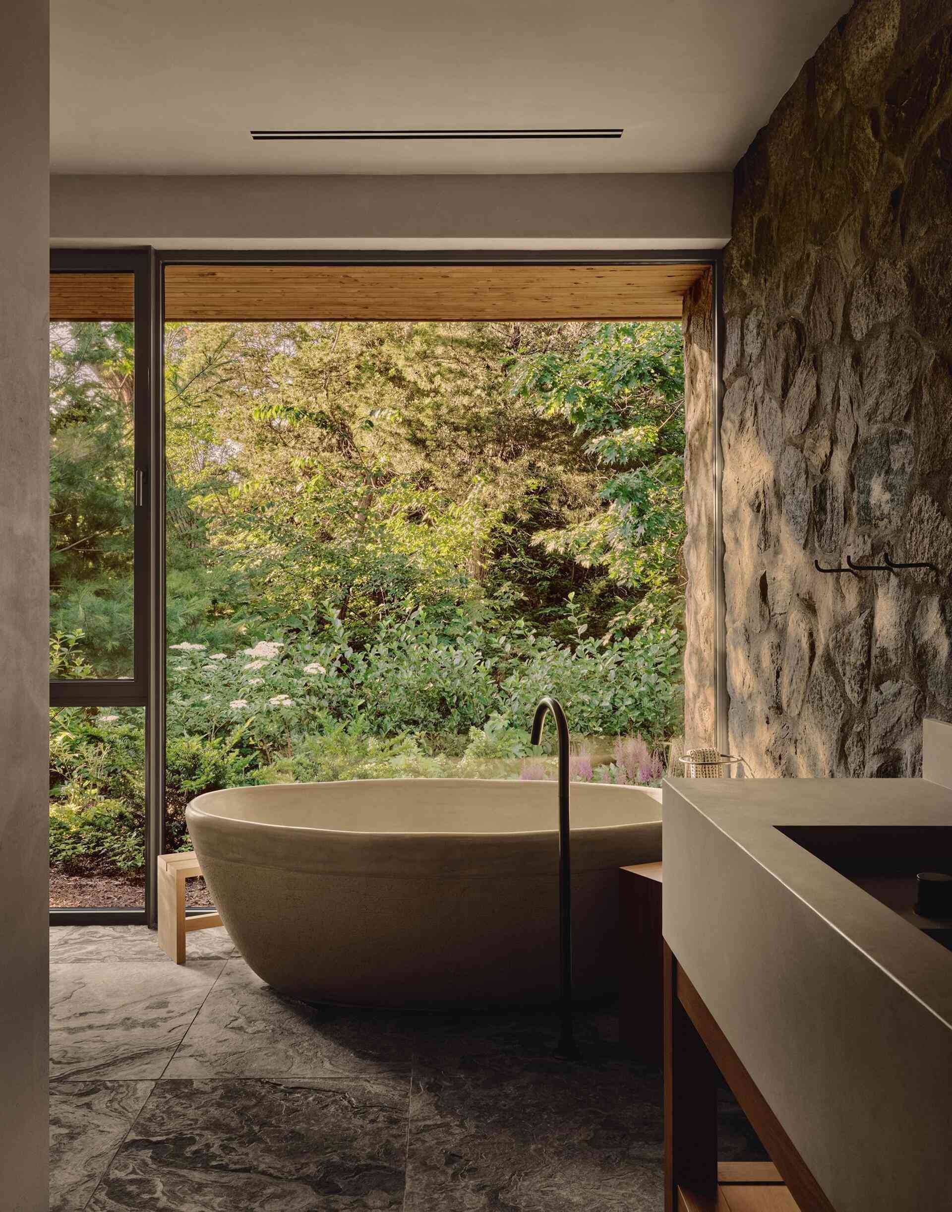 Stone sinks, a ceramic tub and textured shower flooring make this ensuite beautifully timeless.