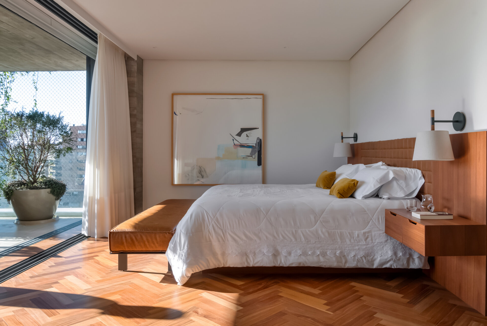Leather-lined joinery, custom furniture and a private sitting area give this bedroom the feel of a luxury hotel suite.