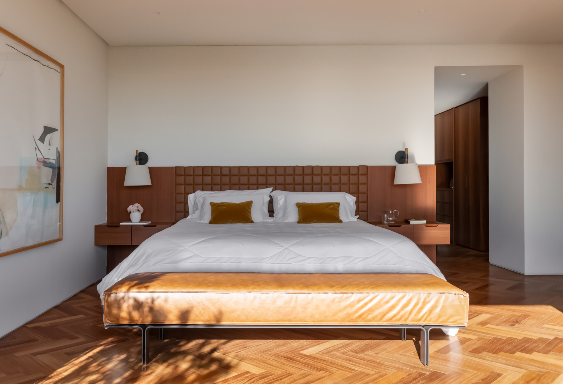 Leather-lined joinery, custom furniture and a private sitting area give this bedroom the feel of a luxury hotel suite.