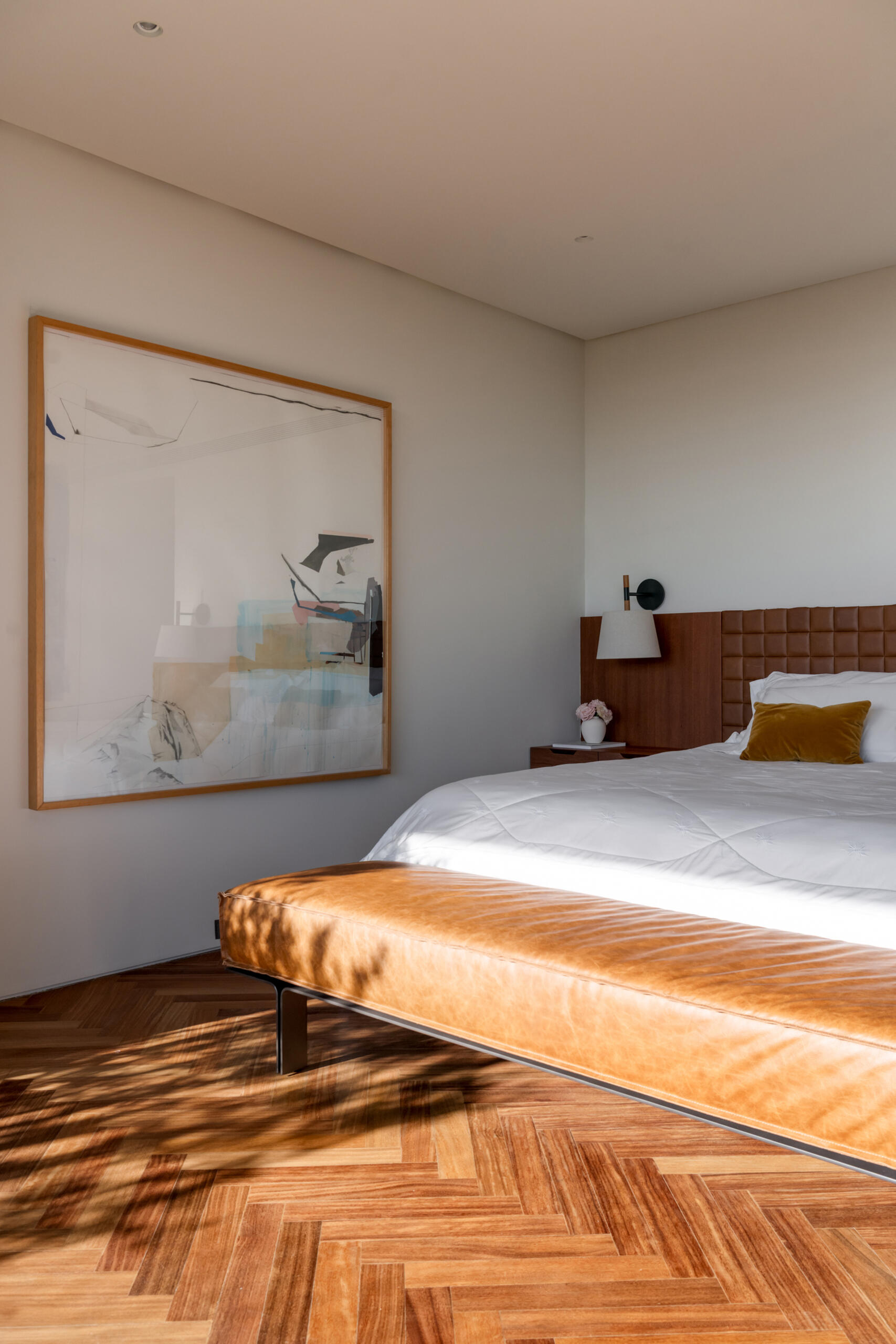 Leather-lined joinery, custom furniture and a private sitting area give this bedroom the feel of a luxury hotel suite.