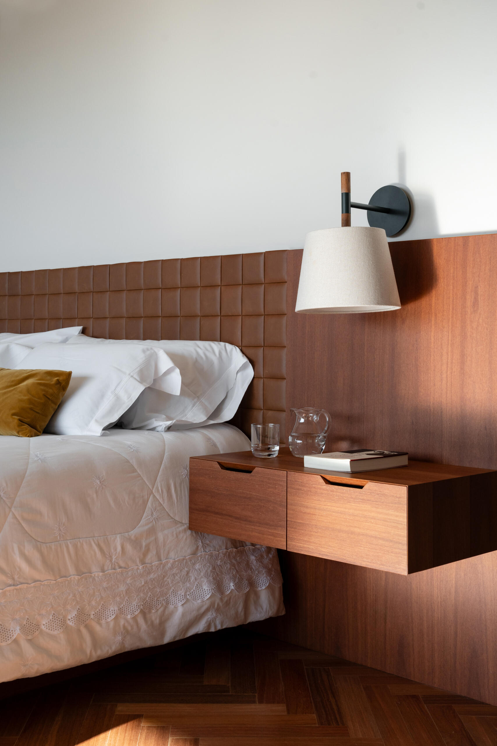 Leather-lined joinery, custom furniture and a private sitting area give this bedroom the feel of a luxury hotel suite.