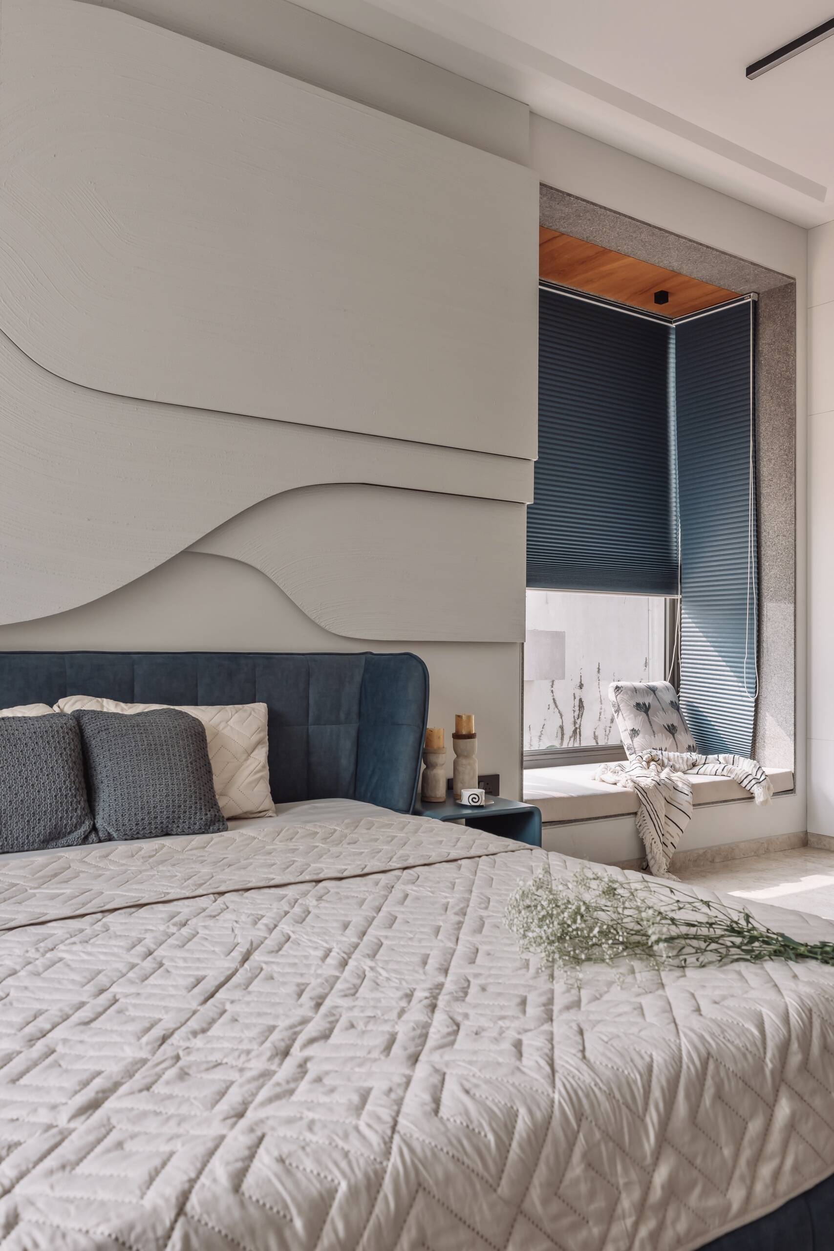 Wave-inspired wall panels, colourful furniture and an indoor swing make this bedroom one of the home's most playful spaces.