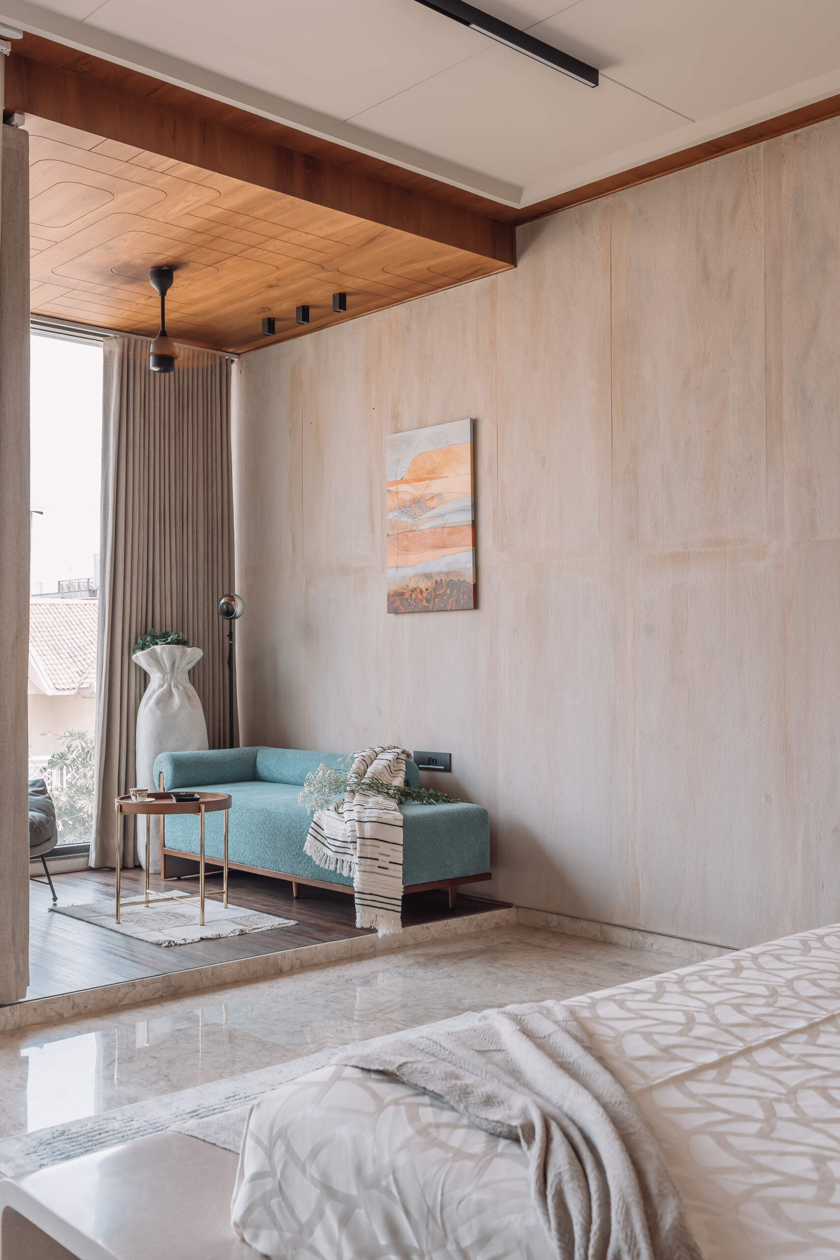 Sandstone walls, brass inlays and custom cabinetry give this elegant bedroom plenty of warmth and character.