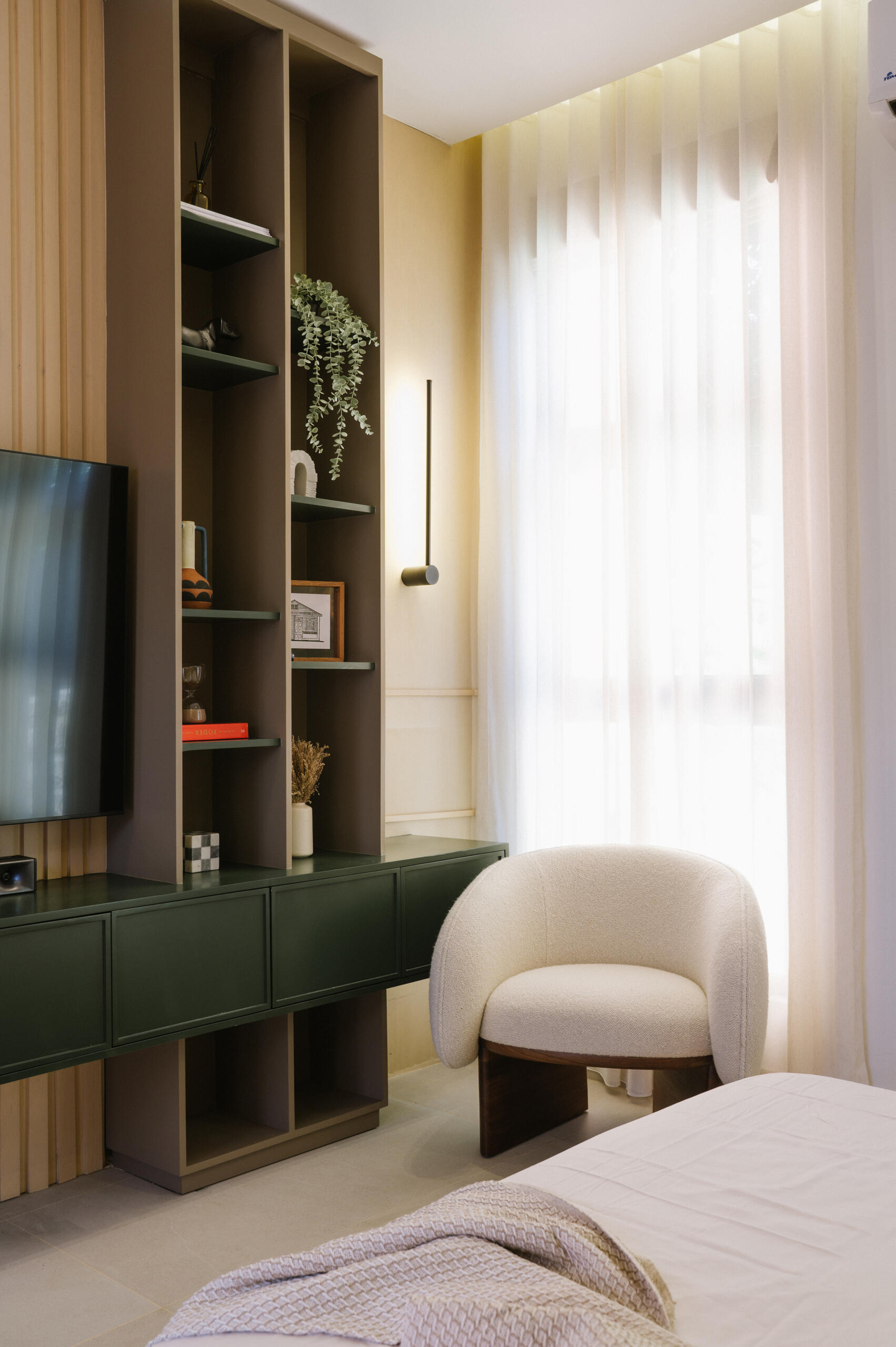 Get bedroom inspiration from this modern space featuring a natural stone feature wall, TV unit and a warm neutral colour palette.