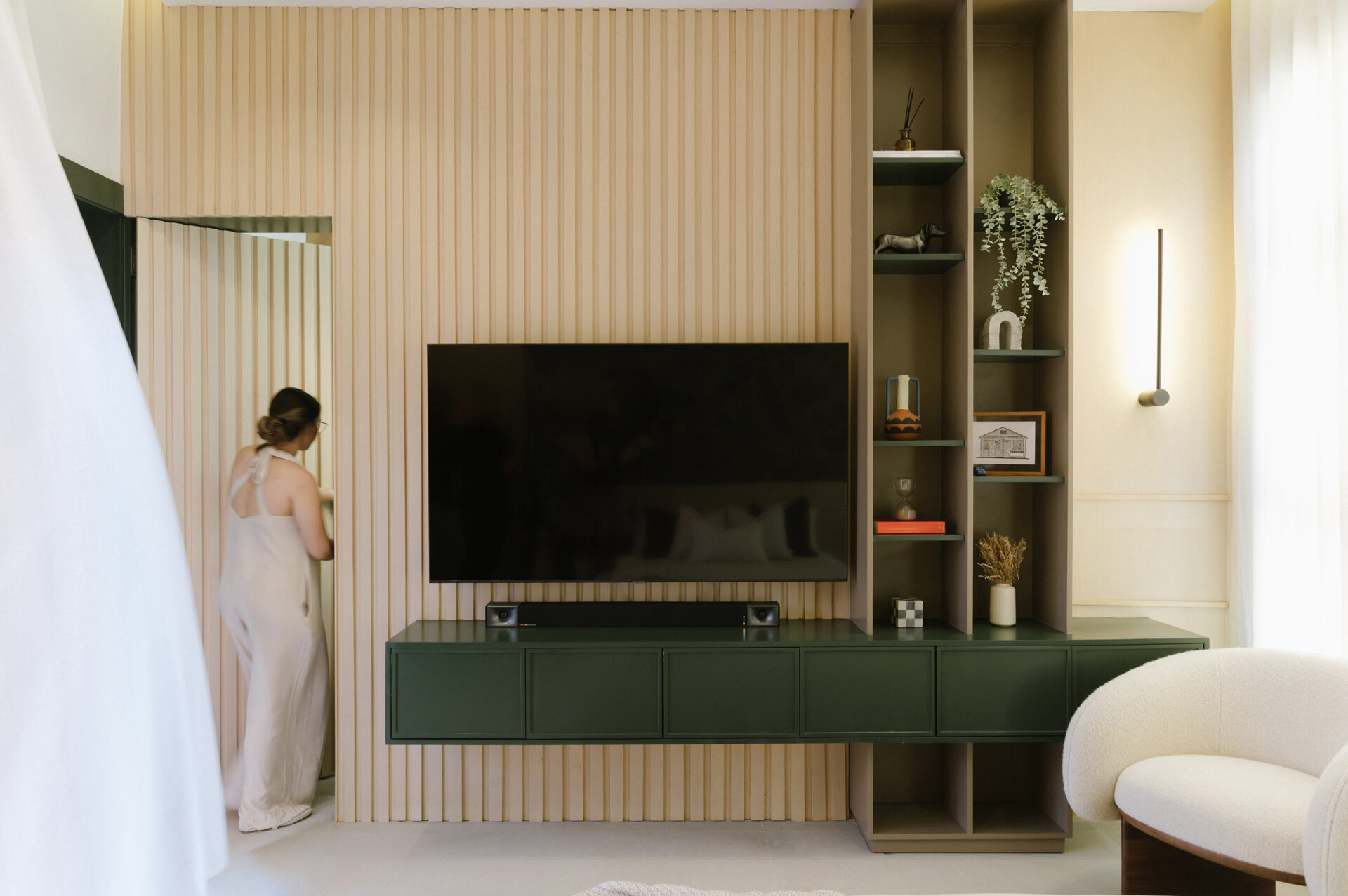 Get bedroom inspiration from this modern space featuring a natural stone feature wall, TV unit and a warm neutral colour palette.
