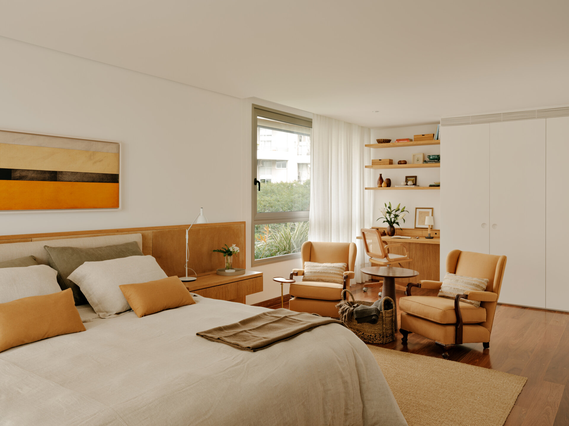 Family artwork inspired the colours of this warm contemporary bedroom filled with custom joinery and natural materials.