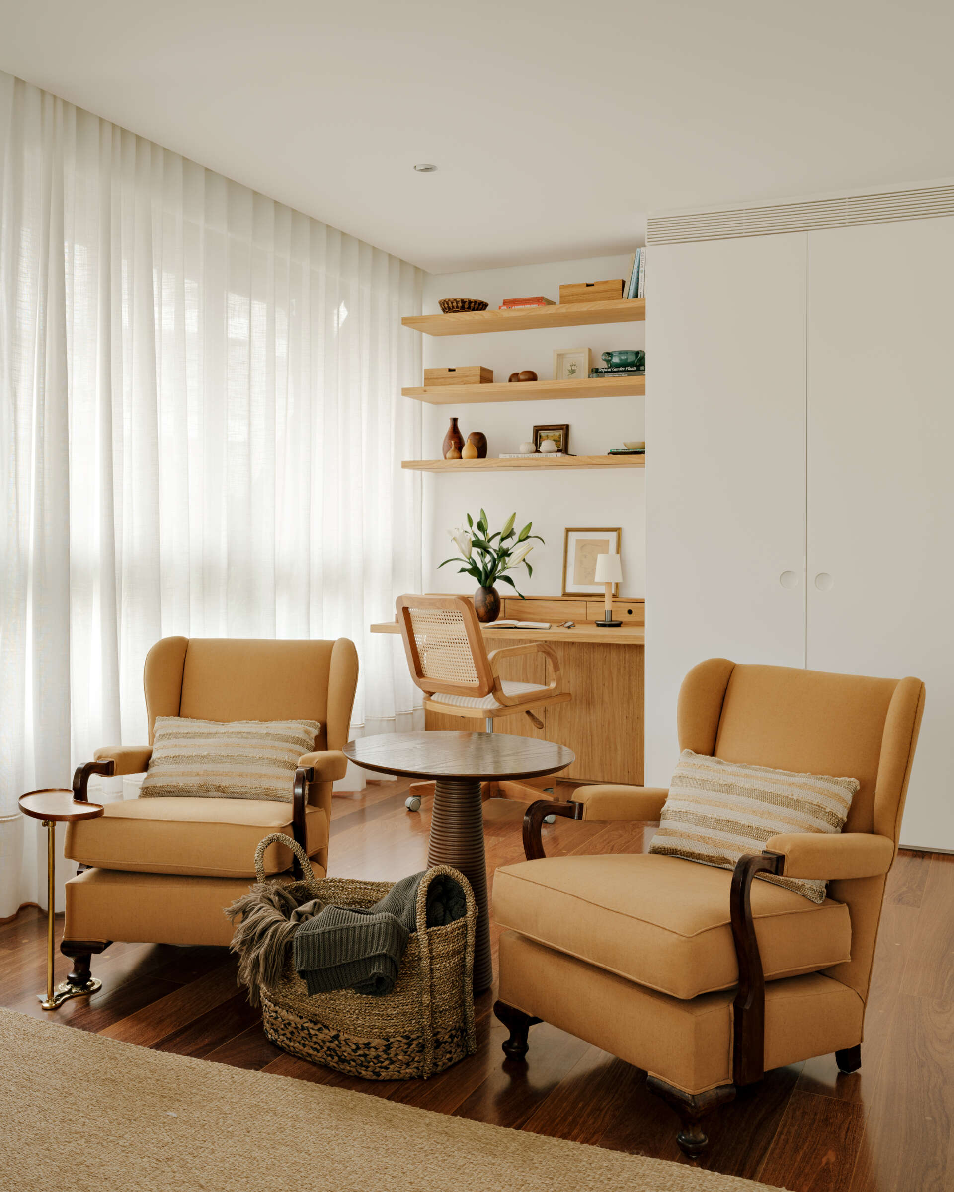 Family artwork inspired the colours of this warm contemporary bedroom filled with custom joinery and natural materials.