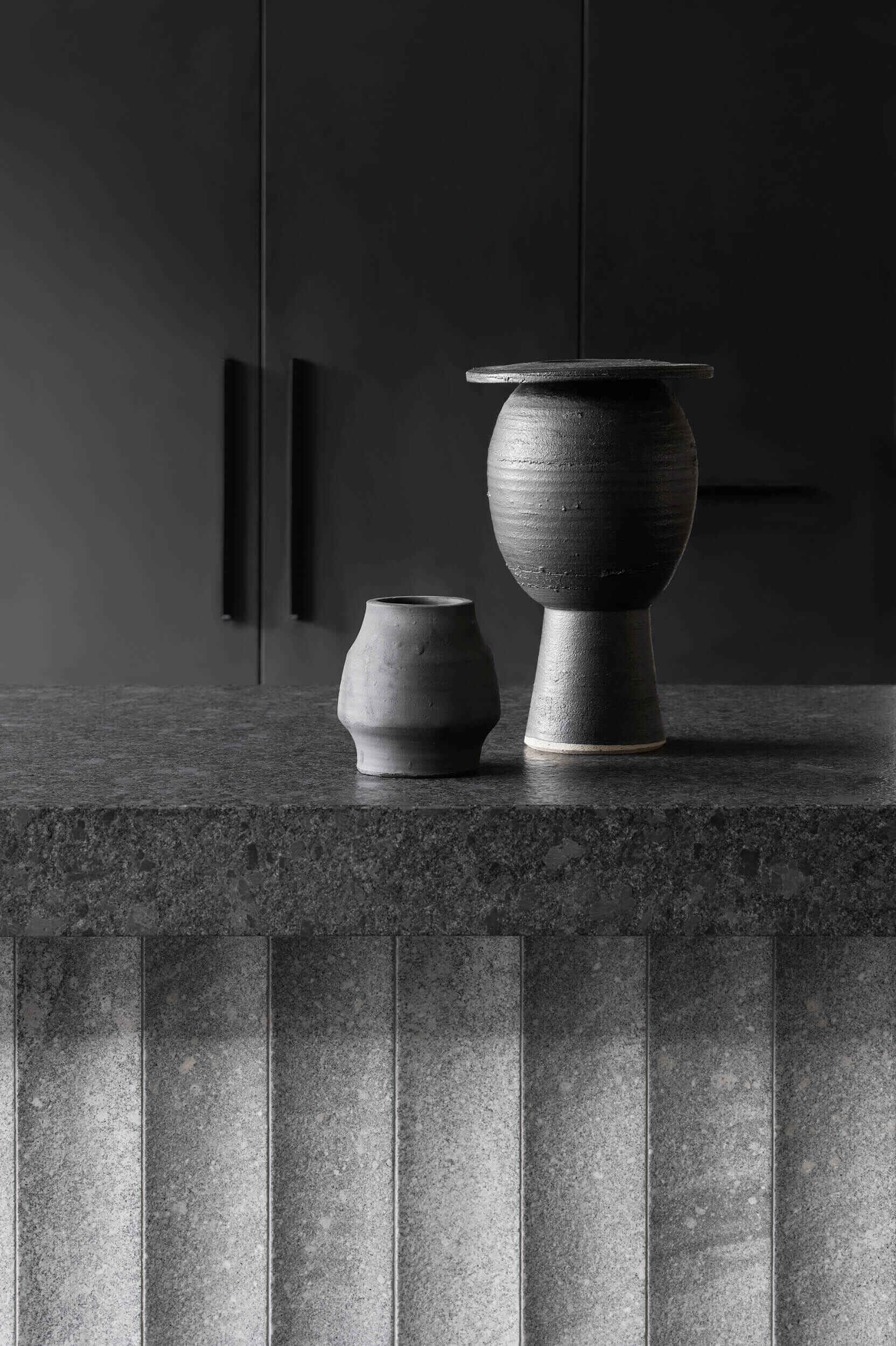 Floating steel, carved granite, recycled brick and blackbutt timber give this industrial-inspired kitchen a sophisticated modern look.