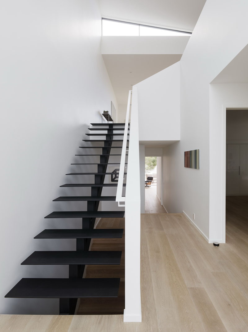See why this architect-designed home places its living room upstairs for brighter spaces and loft-style living.