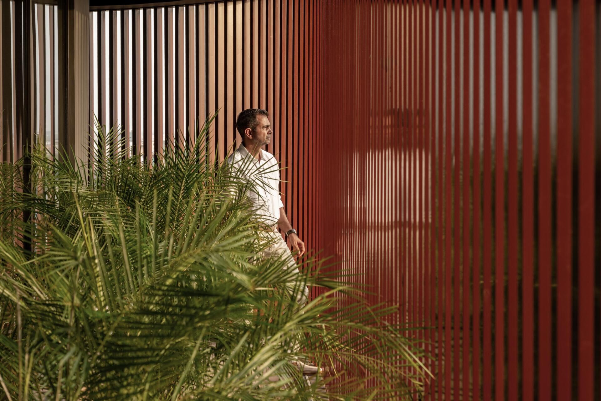 This office building combines capsule-shaped architecture, flexible workspaces, rooftop gardens, planter terraces, natural ventilation, and passive cooling strategies to create a greener, more comfortable workplace in one of India's hottest climates.
