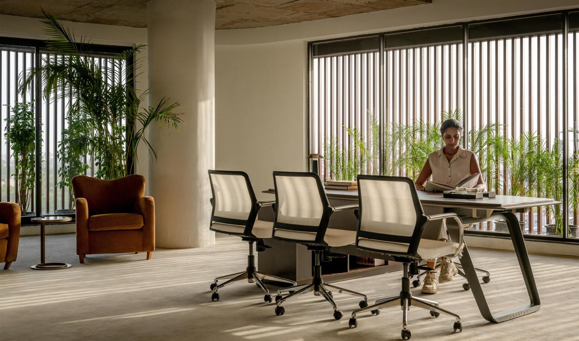 This office building combines capsule-shaped architecture, flexible workspaces, rooftop gardens, planter terraces, natural ventilation, and passive cooling strategies to create a greener, more comfortable workplace in one of India's hottest climates.