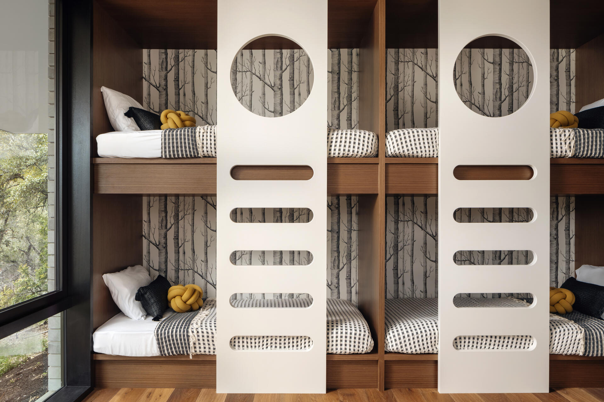 A practical bunk room offers flexible sleeping space within the home's sheltered lower level.