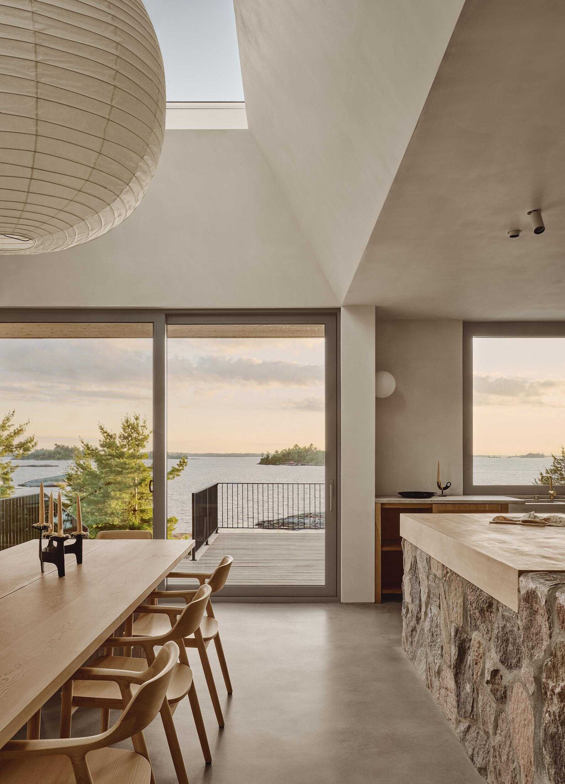 A handcrafted timber dining table overlooking a dramatic stone fireplace makes this dining room unforgettable.