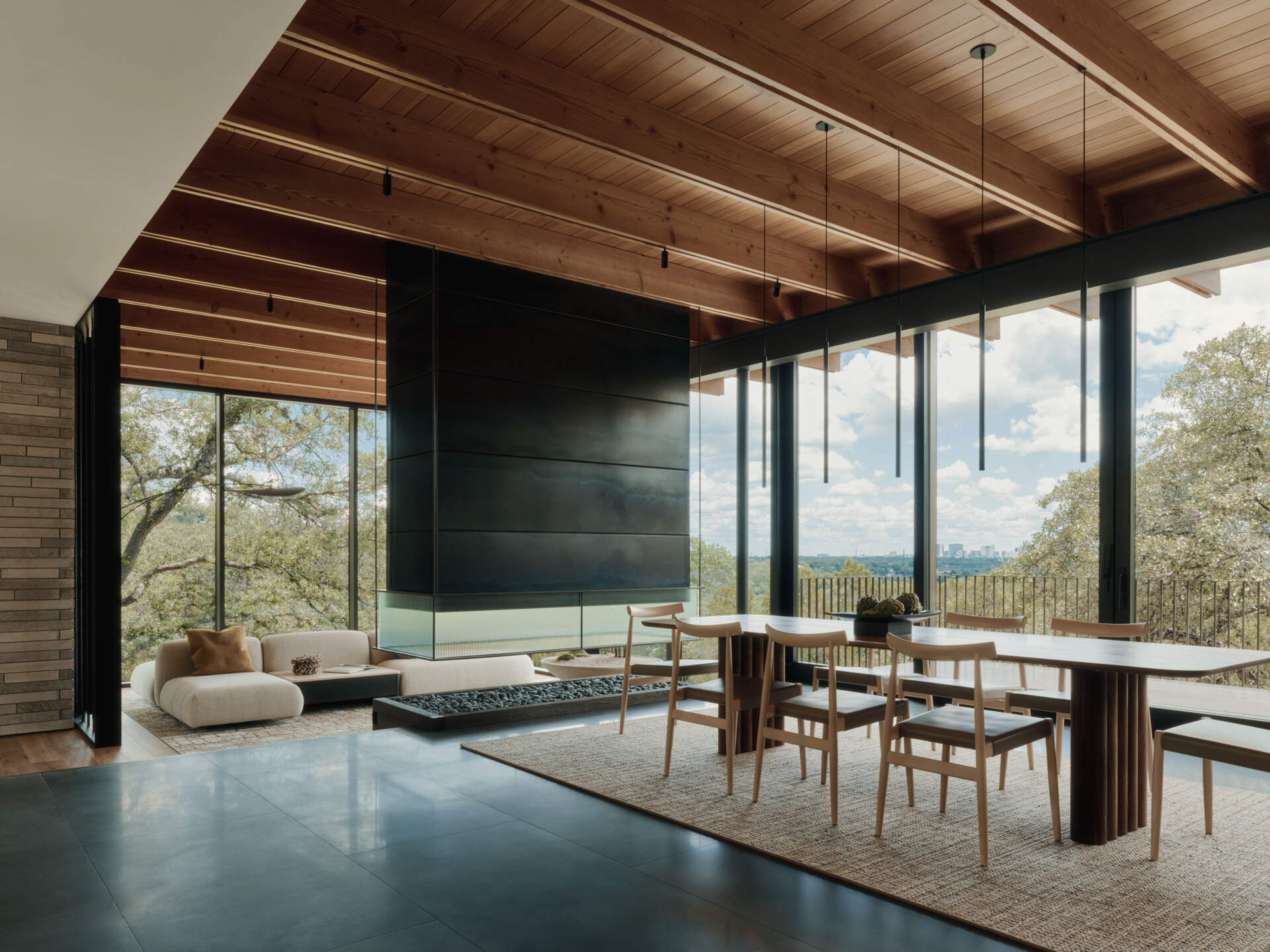 This dining room pairs warm timber finishes with sweeping views across the Texas Hill Country.