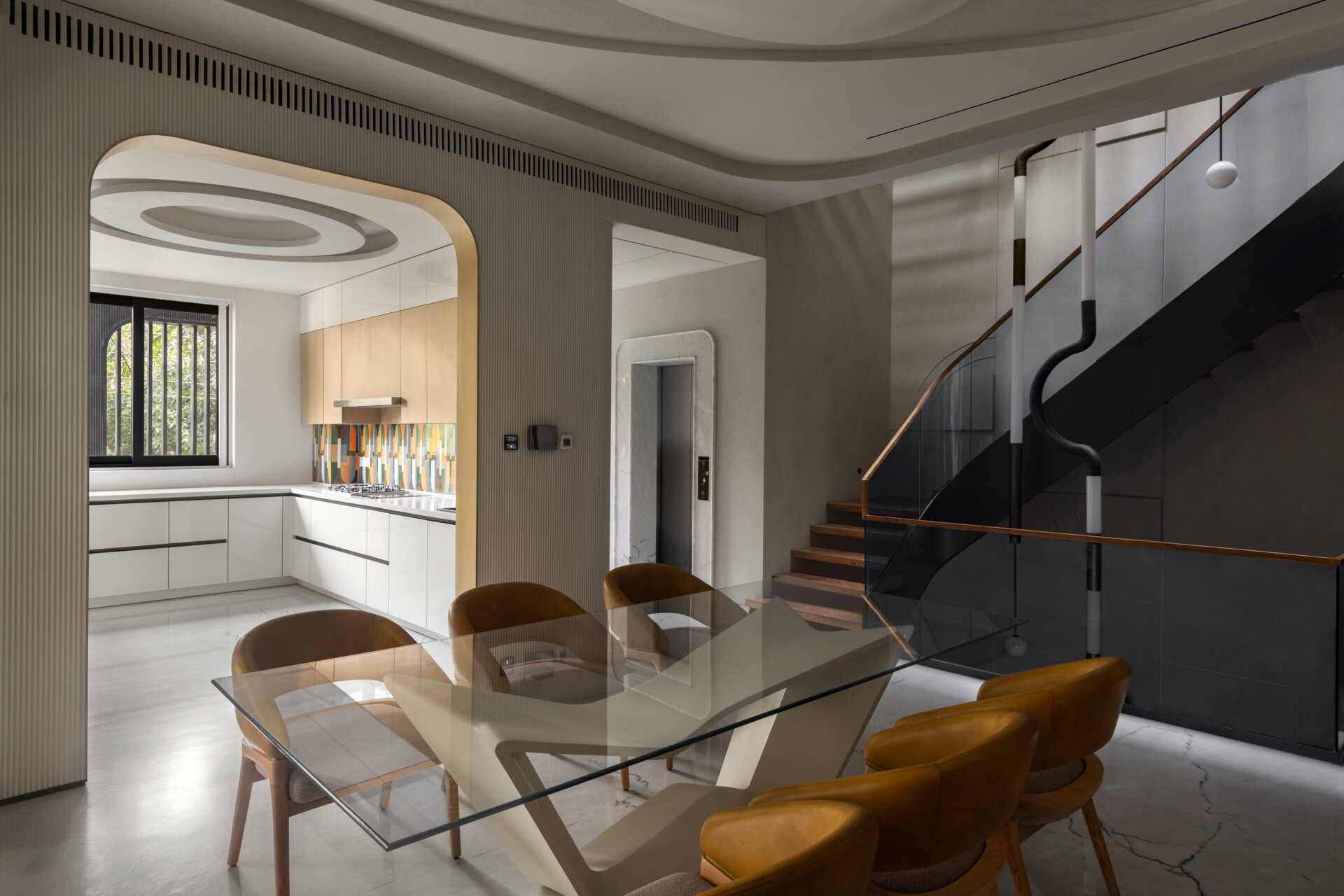 Take a look inside the central dining room that connects the home's social spaces with elegant simplicity.
