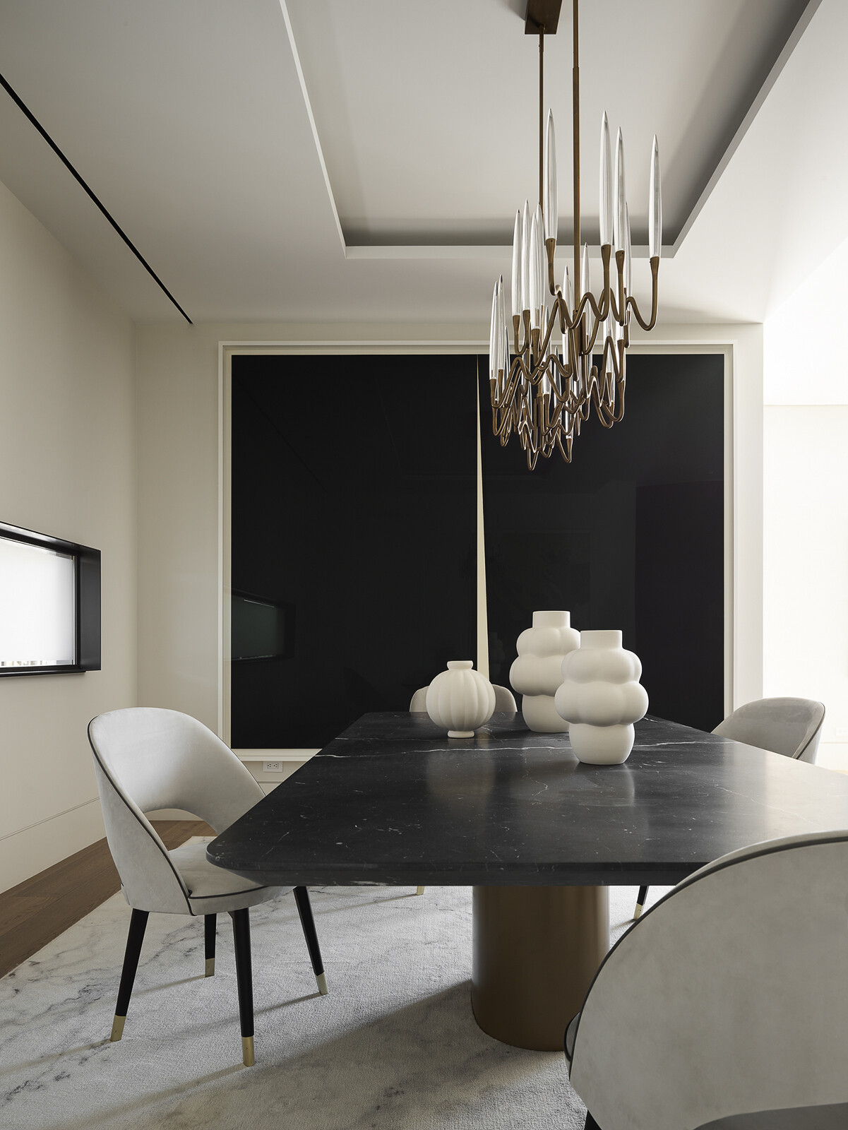 A shimmering metallic artwork becomes the centerpiece of this contemporary dining room, catching natural light and casting a warm glow throughout the space. Paired with sculptural lighting and refined furnishings, it creates an elegant setting where art and everyday living come together.