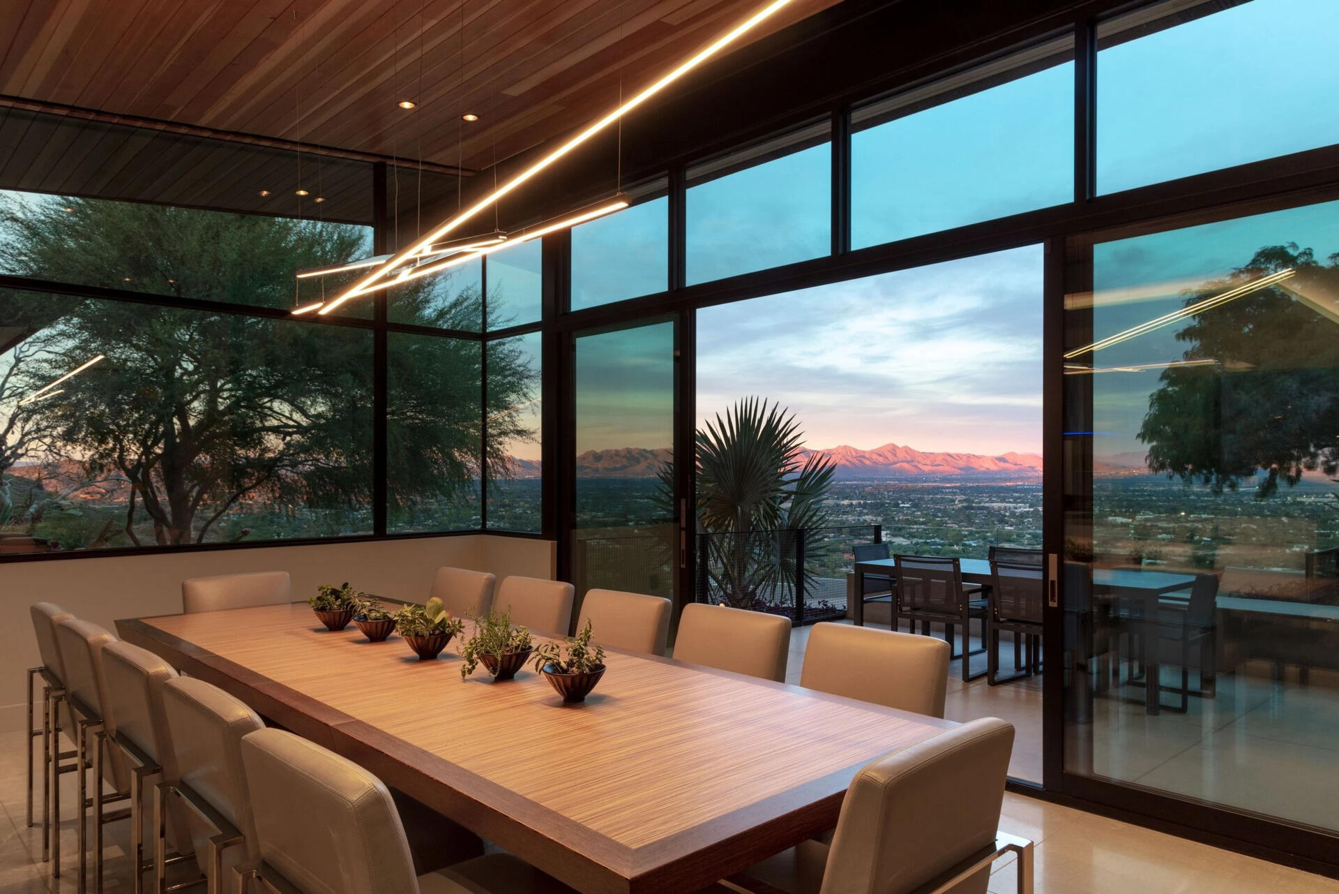 This dining space pairs panoramic mountain and city views with seamless access to outdoor entertaining areas.