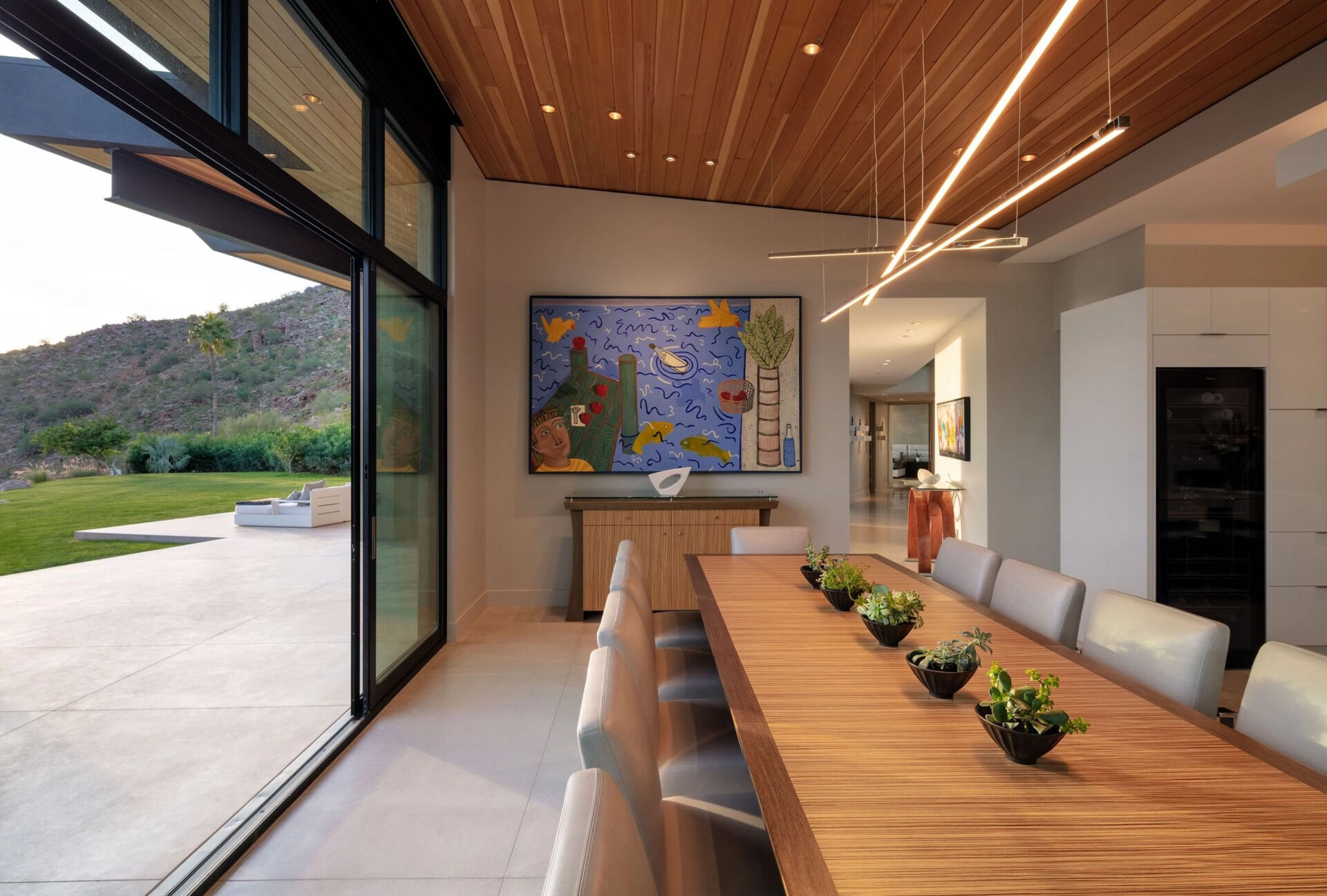 This dining space pairs panoramic mountain and city views with seamless access to outdoor entertaining areas.