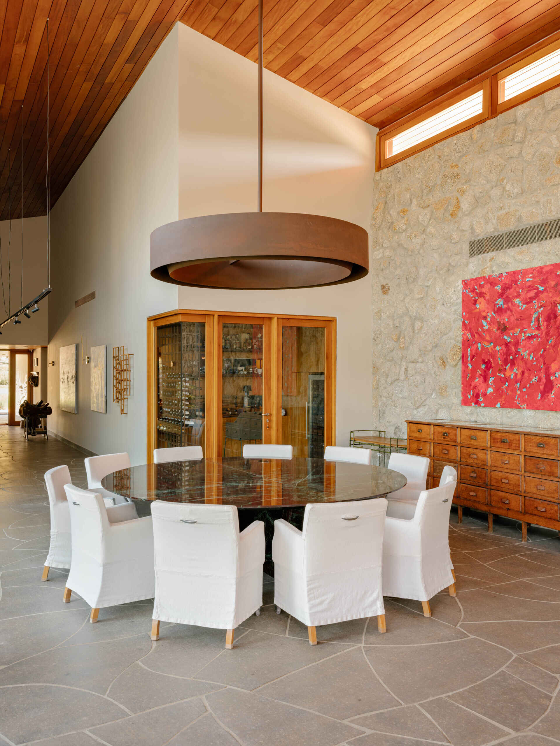 A striking Brazilian marble table anchors this elegant dining room filled with natural textures.