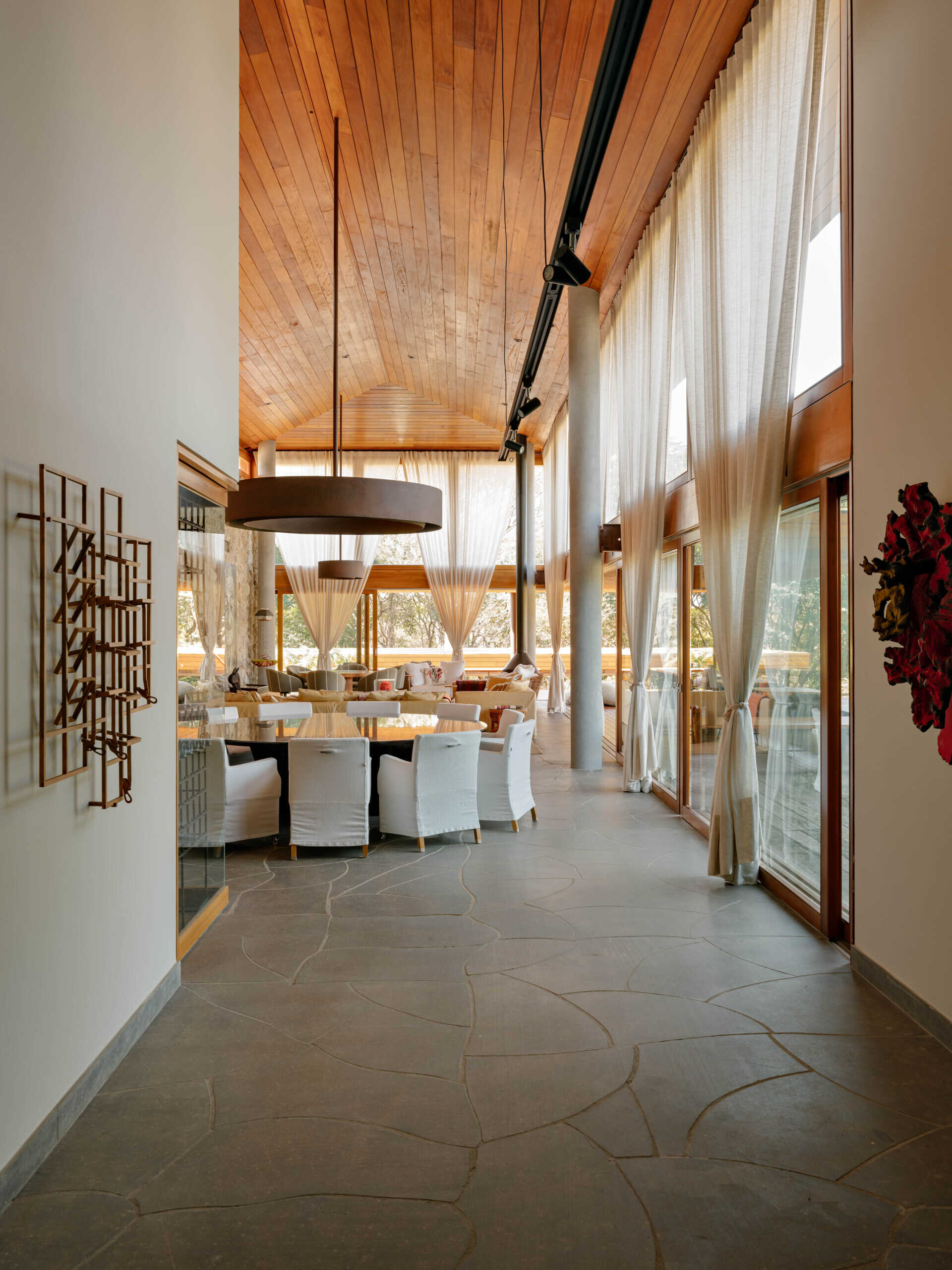 A striking Brazilian marble table anchors this elegant dining room filled with natural textures.