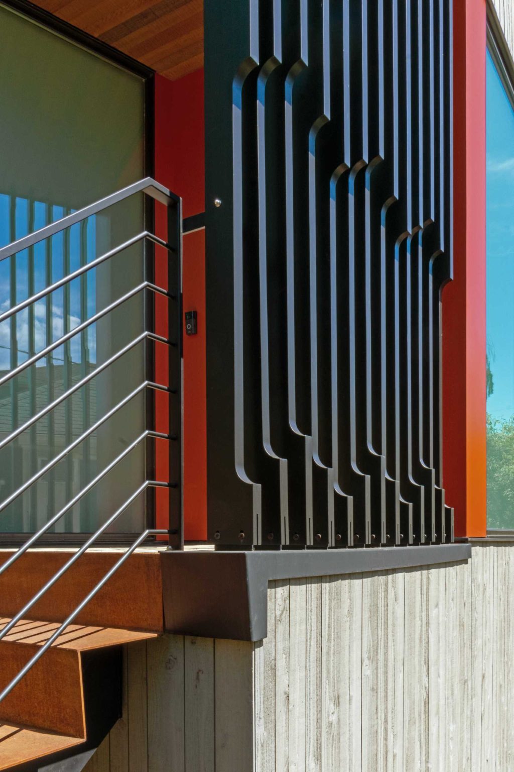 A colorful new front entry, warm wood siding, larger windows, and a welcoming façade completely change the street presence of this renovated Seattle home.