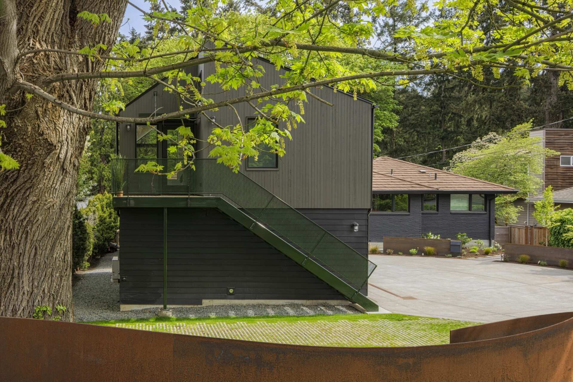 This Seattle garage replacement pairs smart planning with soaring interiors, lake views, and a roof designed with future solar panels in mind.