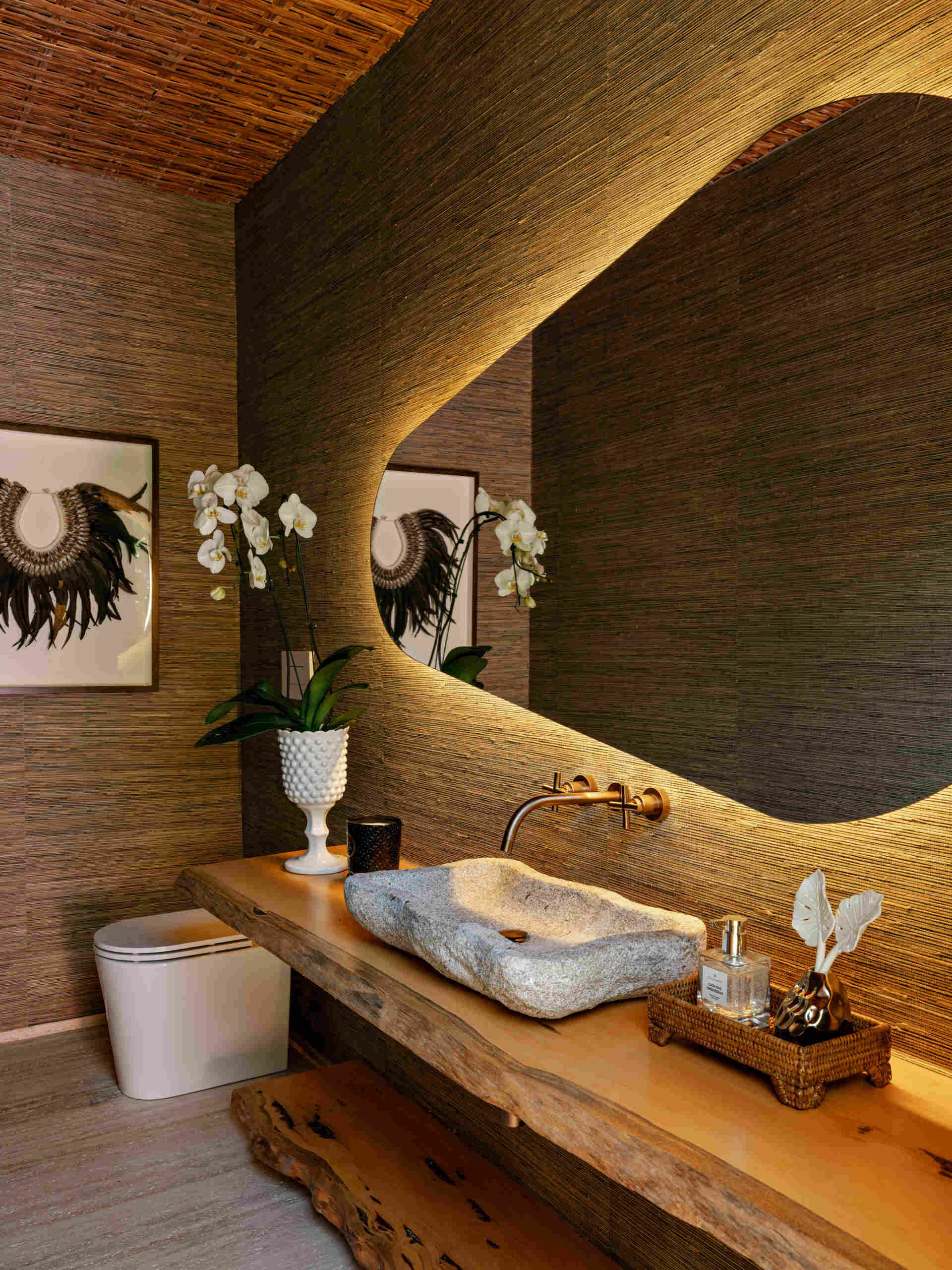 Natural stone and warm timber details give these contemporary guest bathrooms a timeless feel.