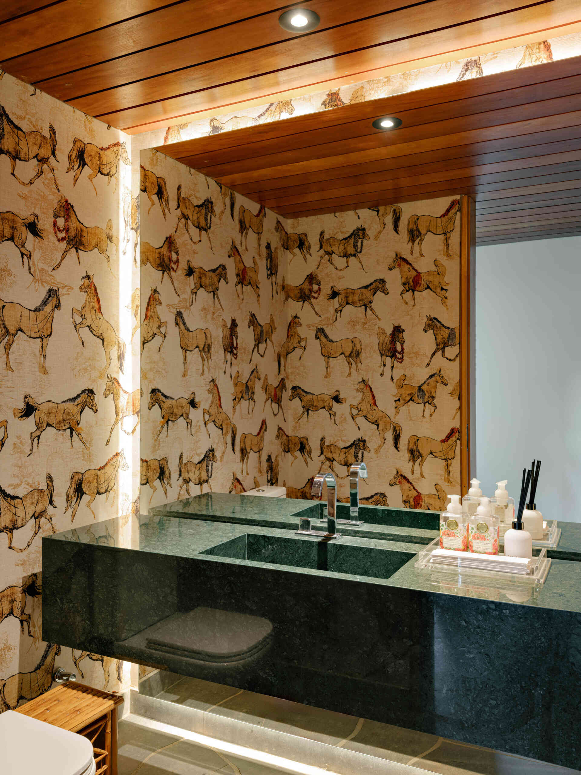 Horse wallpaper gives this guest bathroom a fun twist while complementing the home's natural finishes.