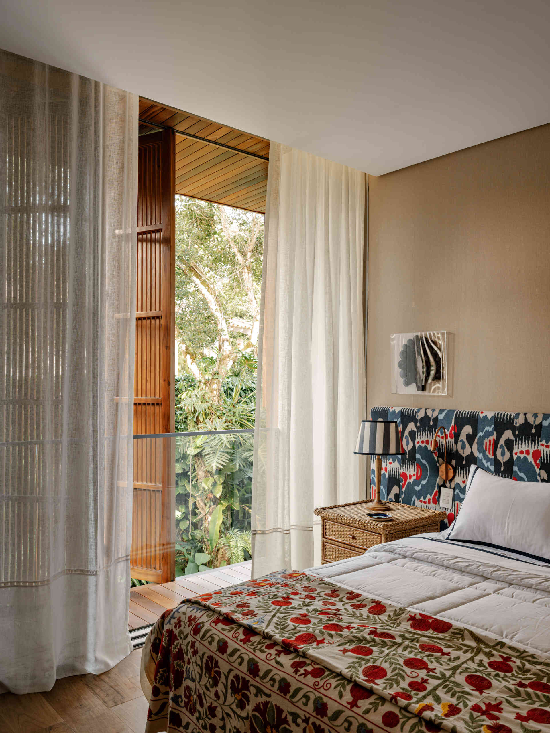These guest bedrooms continue the home's fresh coastal style with soft colours and garden outlooks.