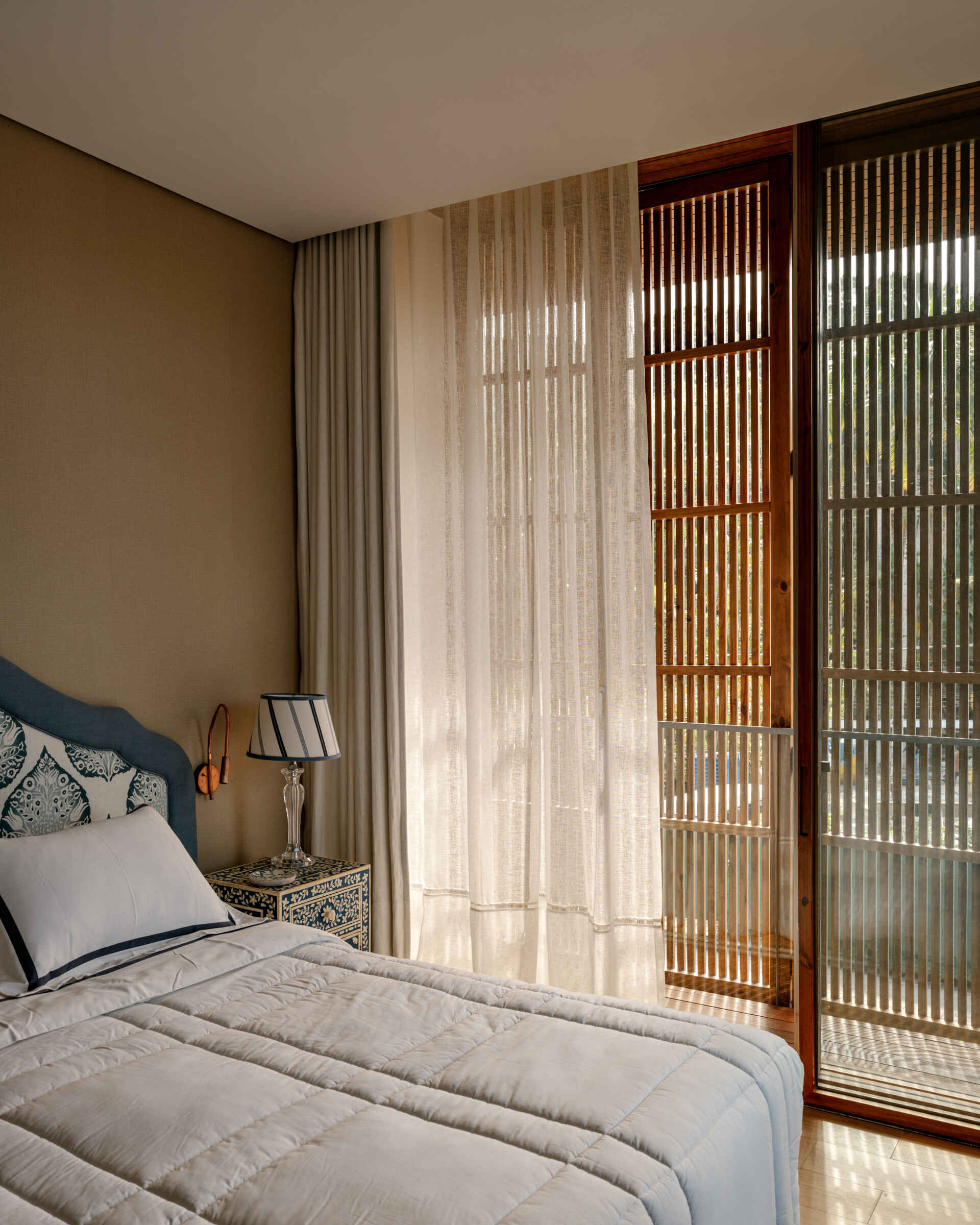 These guest bedrooms continue the home's fresh coastal style with soft colours and garden outlooks.