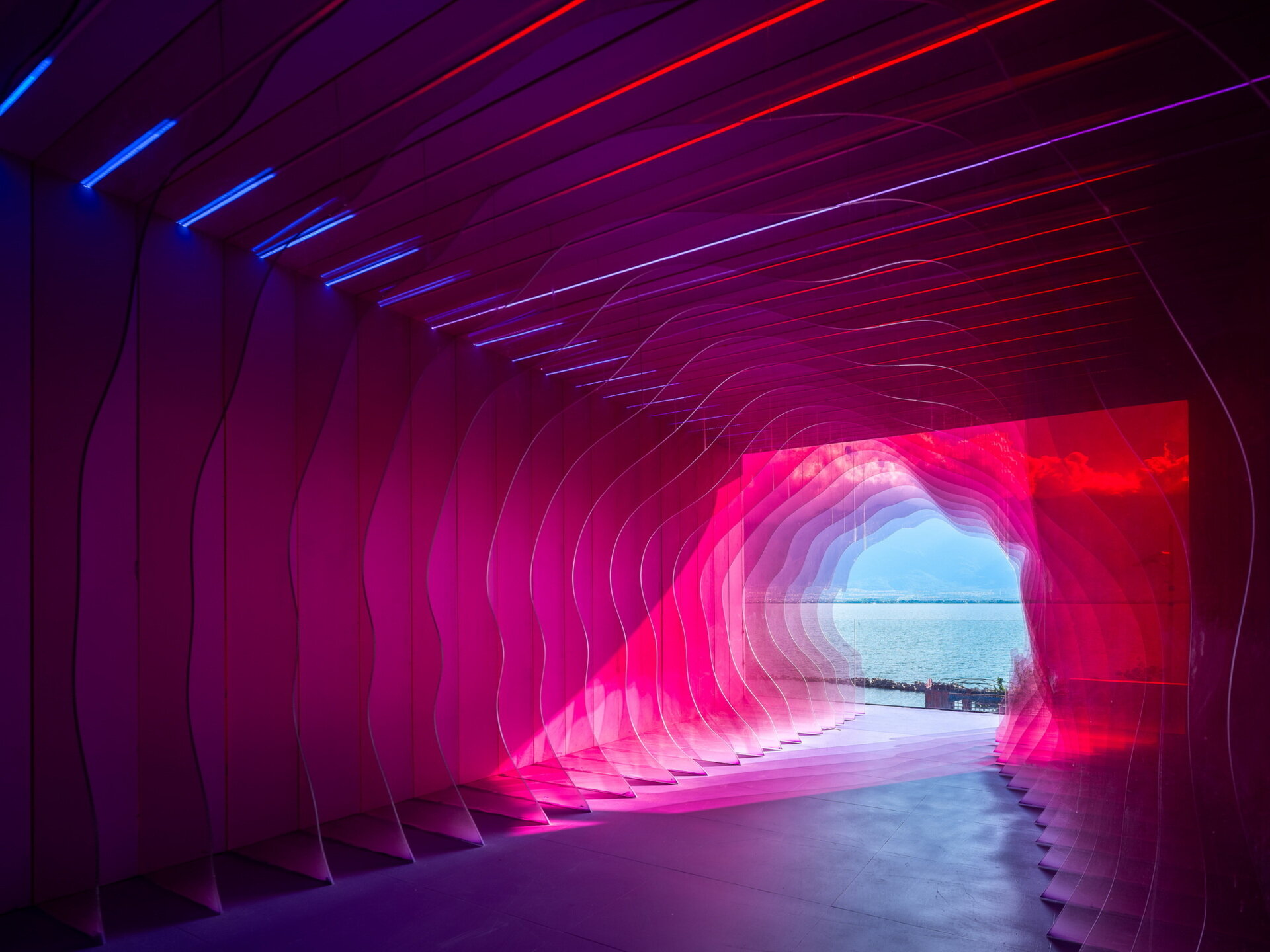 The Blossom Suite surrounds guests with colorful filtered light, creating the feeling of standing inside the center of a giant flower while overlooking Dali's famous scenery.