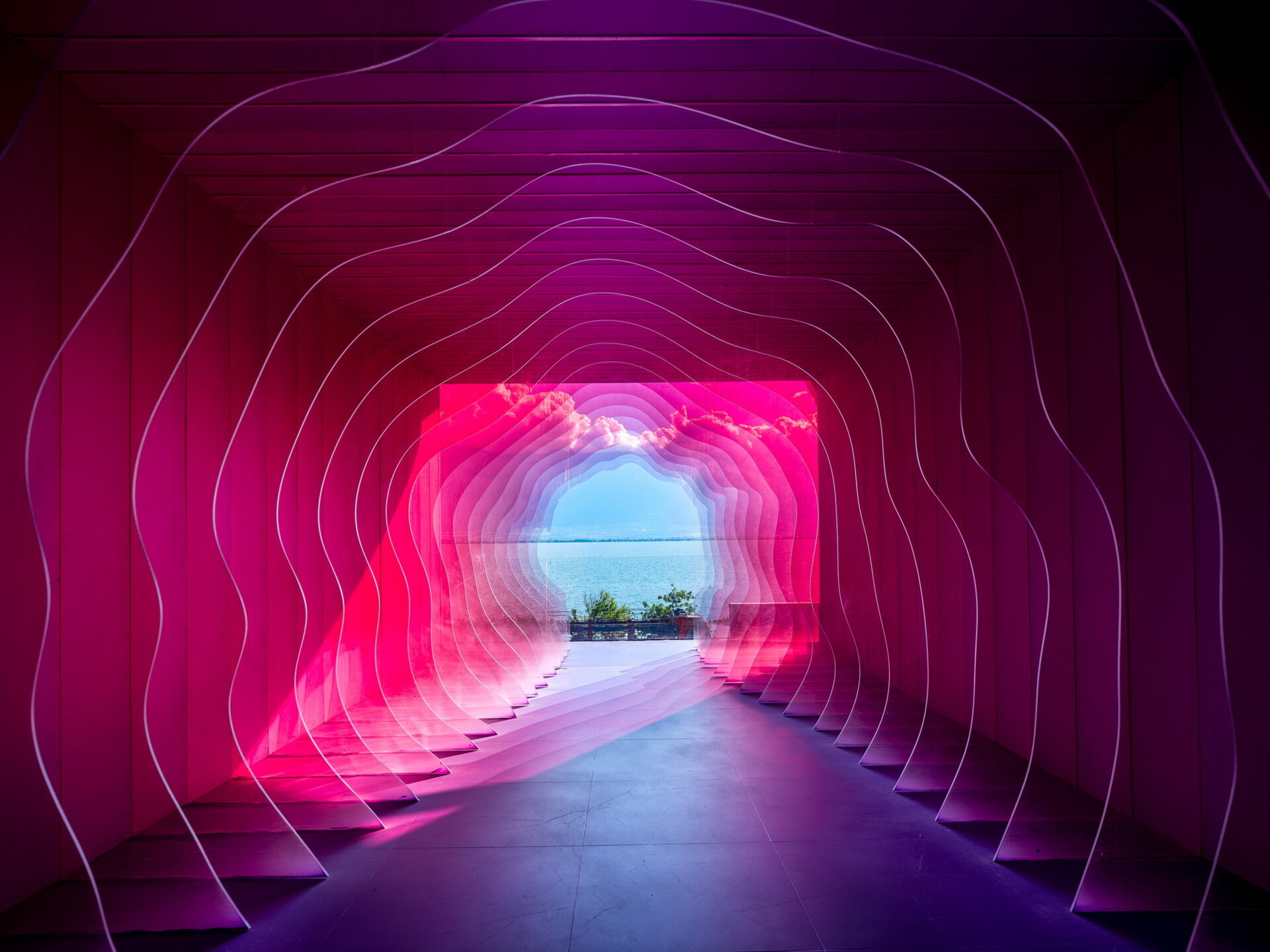 The Blossom Suite surrounds guests with colorful filtered light, creating the feeling of standing inside the center of a giant flower while overlooking Dali's famous scenery.