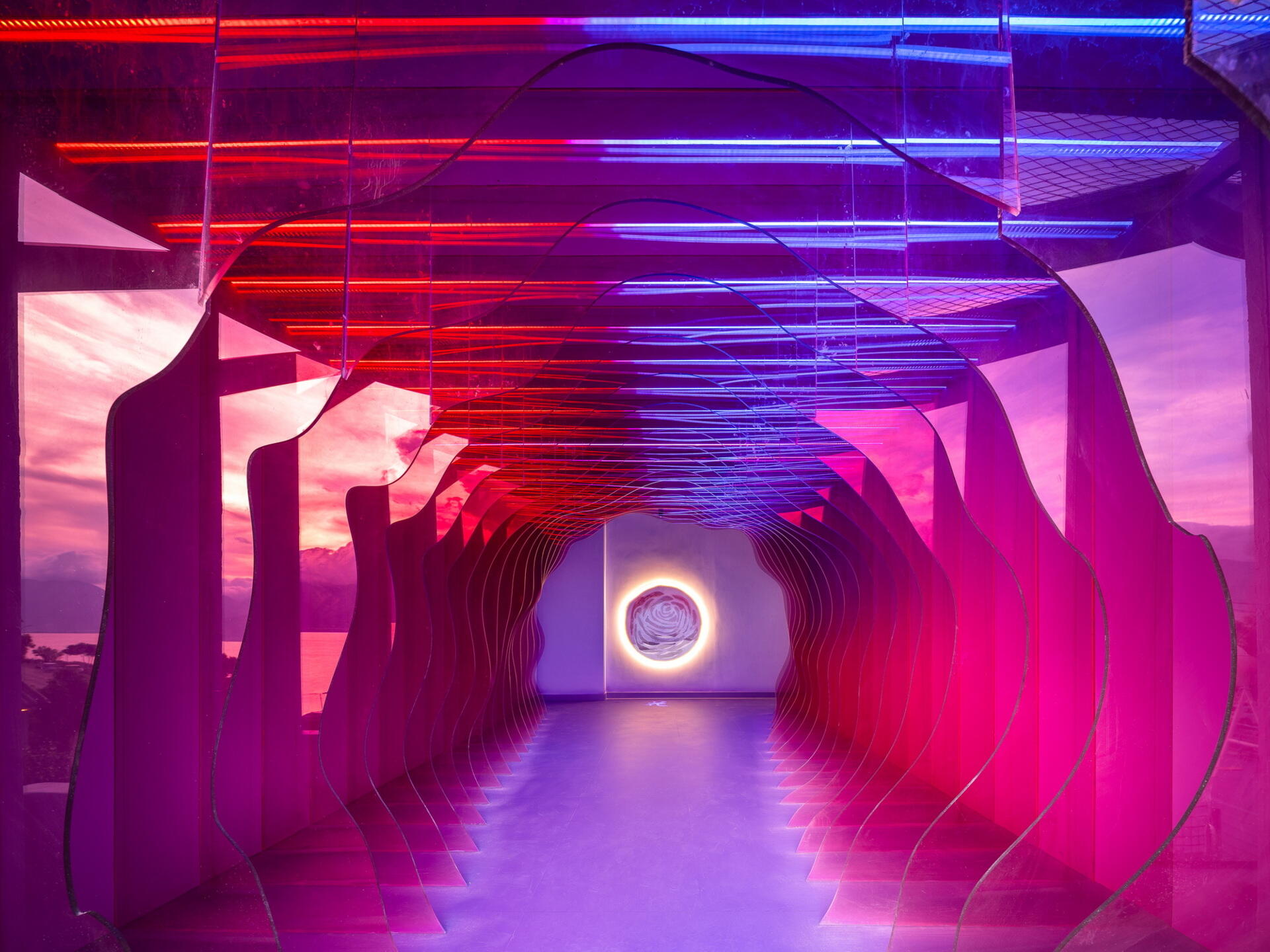 The Blossom Suite surrounds guests with colorful filtered light, creating the feeling of standing inside the center of a giant flower while overlooking Dali's famous scenery.