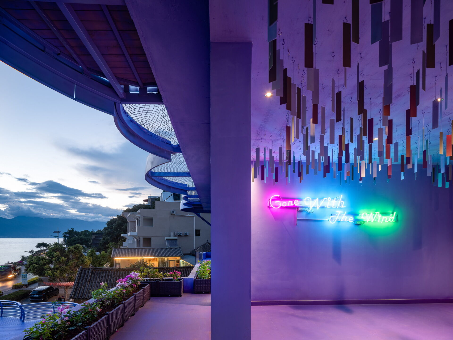 Ultra-thin violet metal panels sway gently overhead in the Wind Suite, allowing guests to see and hear the movement of air throughout the space.