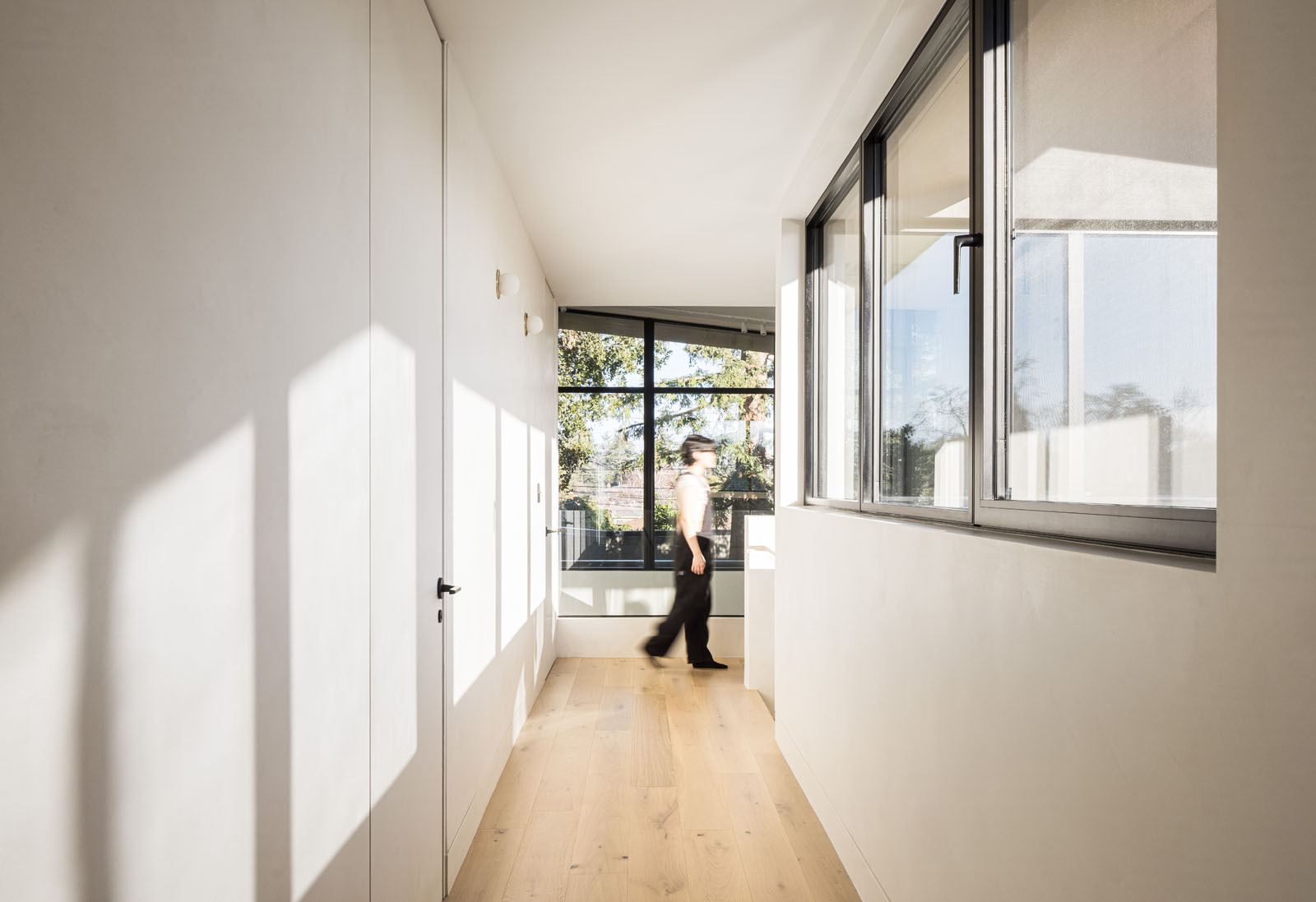 Explore the breezeway and upper-level bridge that connect family spaces while overlooking the bright living room below.